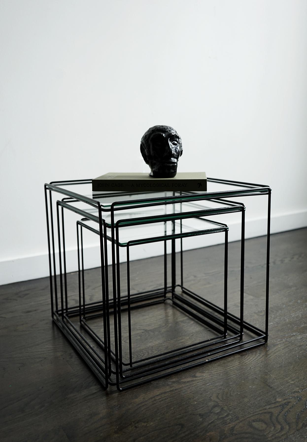 This nest of three Isocele nesting tables originates from France and was manufactured in the 1970s by Arrow. They have a black wire steel frame with glass on top. Designed by Max Sauze and are in very good vintage condition. These Minimalistic