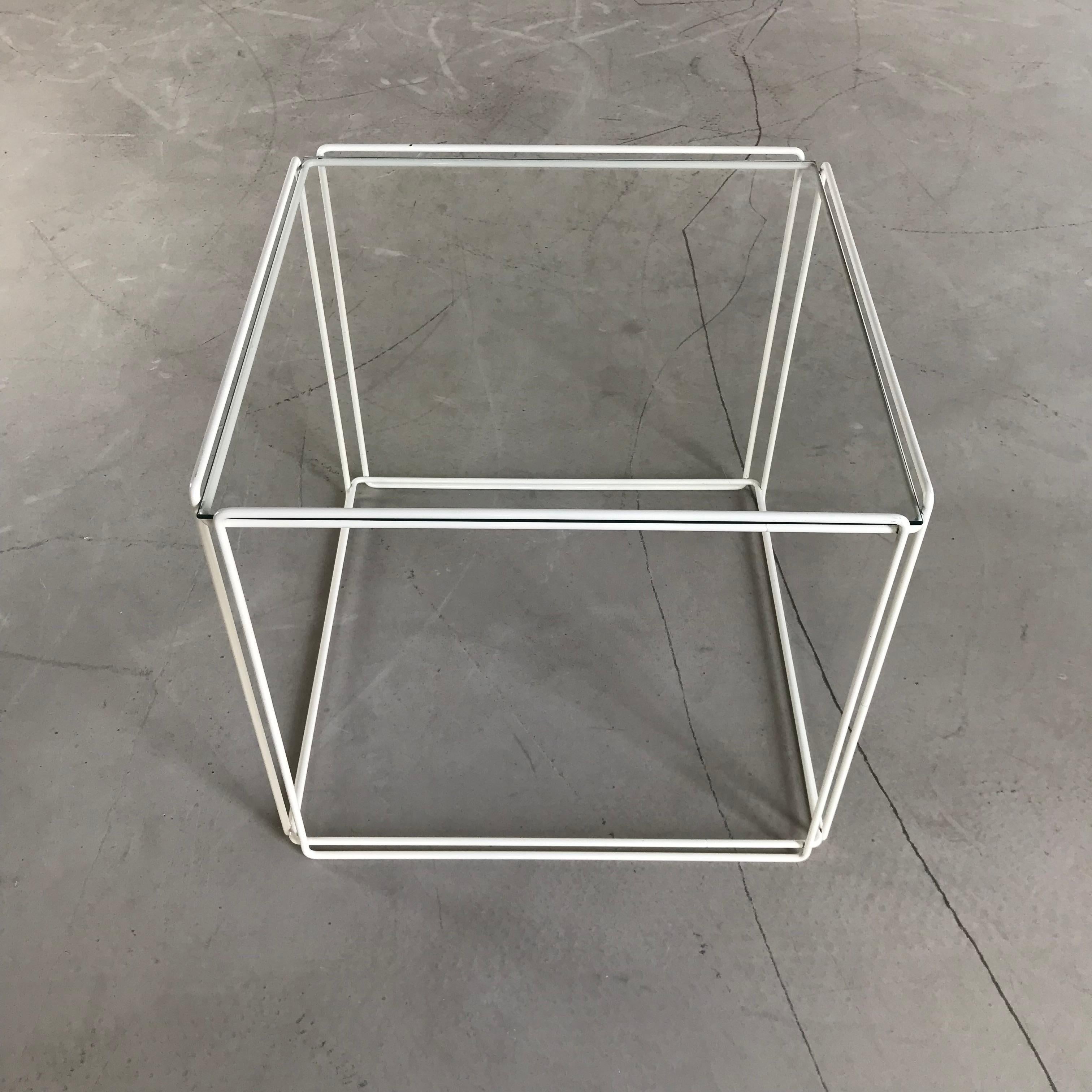 Beautiful, graphical and Minimalist design by Max Sauze for Max Sauze Studio, circa 1970. This table features a white colored metal base and a glass 'shelve'. The glass and metal wire structure gives this table a very transparent, minimal look, but