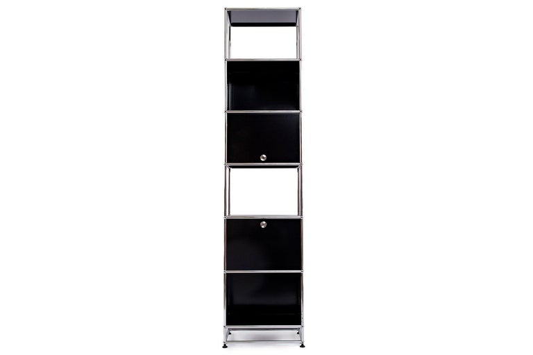 USM Haller bookcase By USM

This USM Haller bookshelf is made of graphite black powder-coated steel panels and chrome plated steel tube frame. Tower has 6 shelves; 2 open, 2 enclosed, 1 door that opens up and 1 door that opens down. This