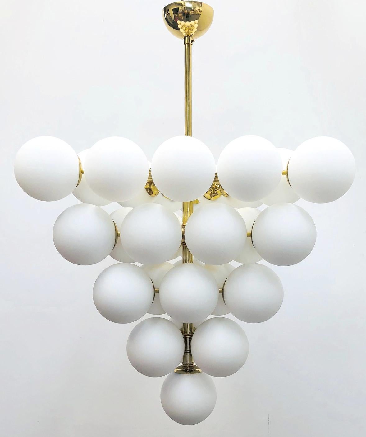 Italian chandelier with matte white Murano glass globes mounted on polished brass frame / Designed by Fabio Bergomi for Fabio Ltd / Made in Italy
31 lights / E12 or E14 type / max 40W each
Diameter: 31.5 inches  / Height: 31.5 inches not including