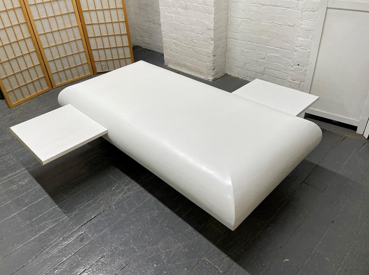 Habillée d'une toile de gazon, la table comporte deux plateaux coulissants et des pieds en laiton. L'avant des plateaux est garni de laiton.
Dans le style de Karl Springer.