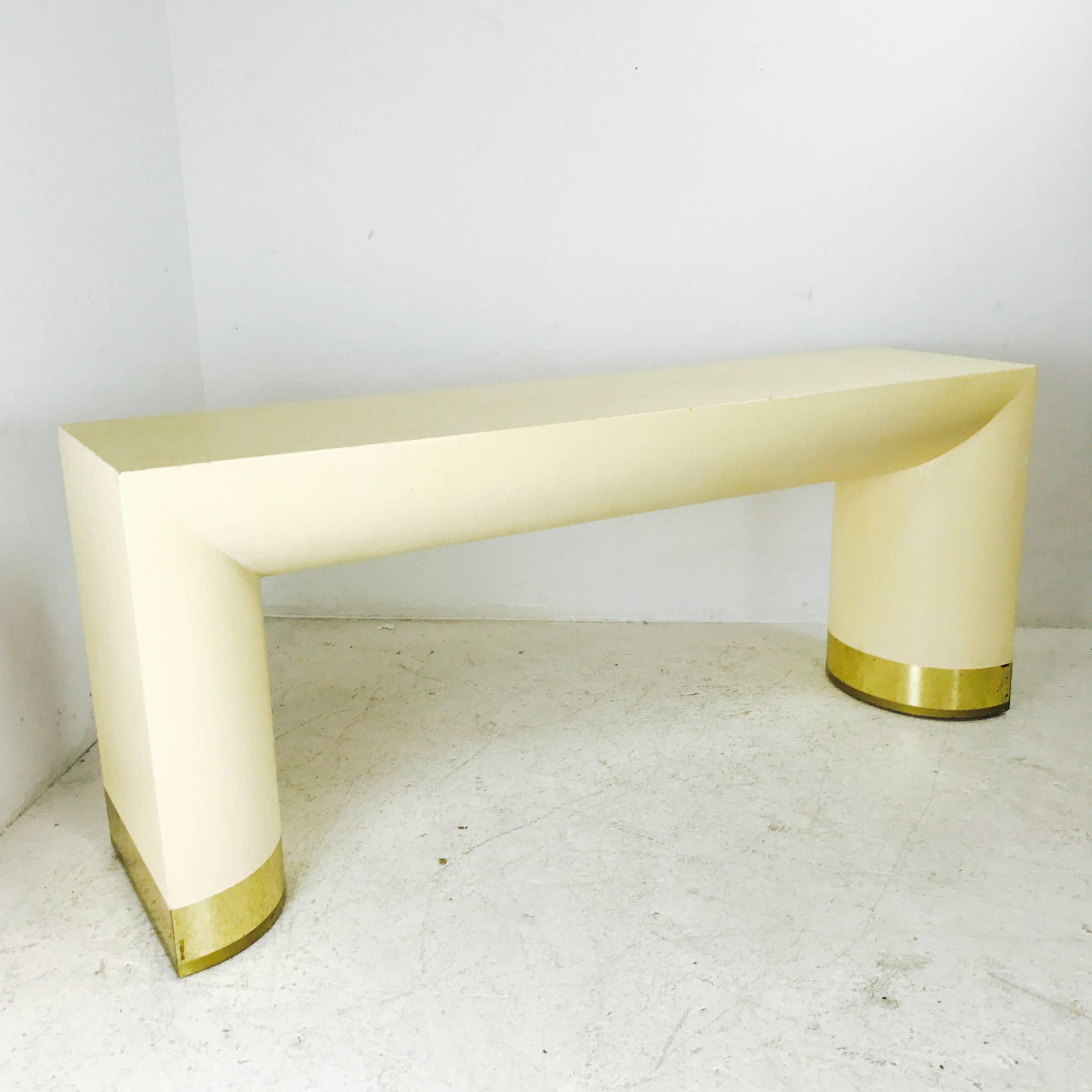 Grasscloth console table with brass feet in the Style of Karl Springer. Console is in found condition with wear from use and needs refinishing.

Dimensions: 72