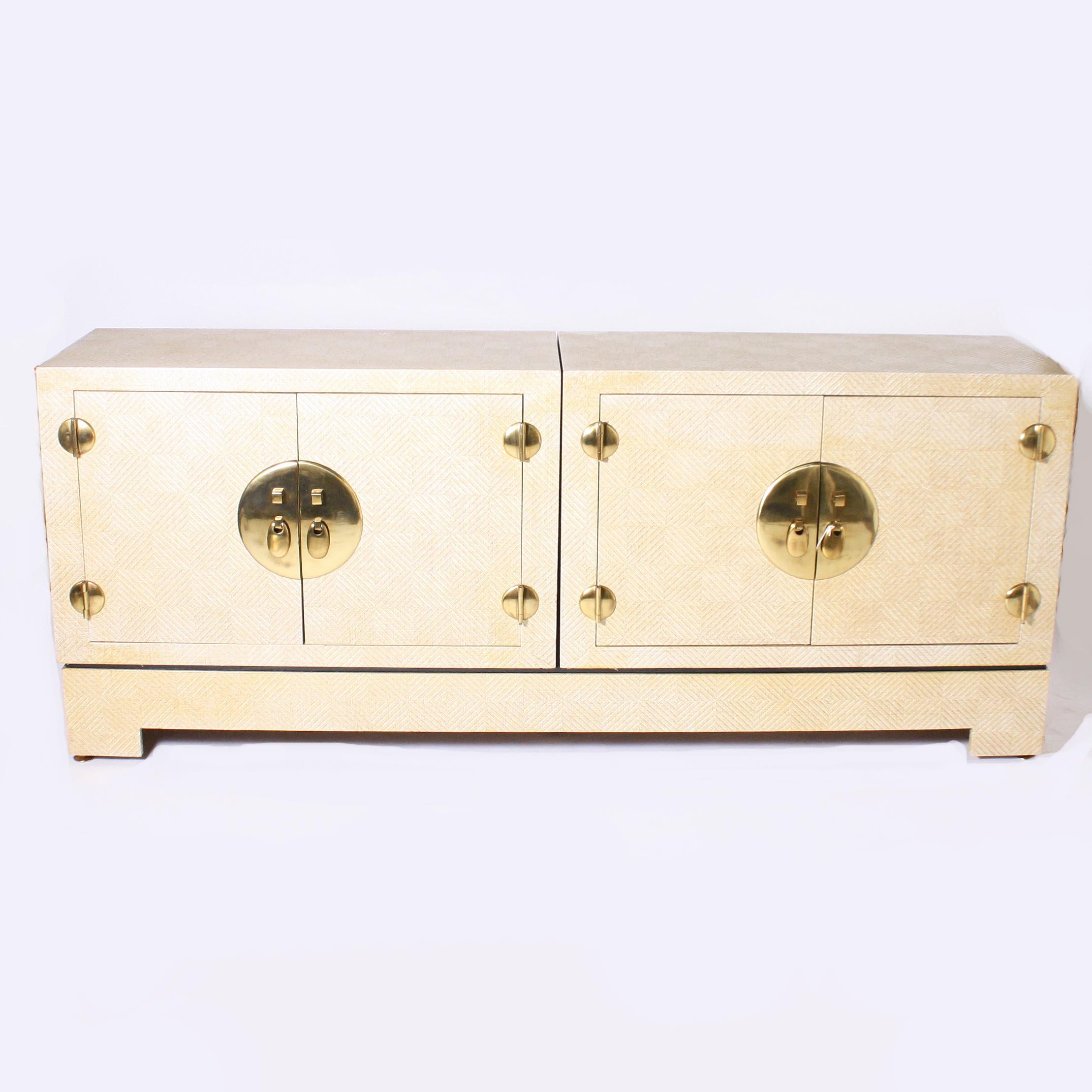 Grasscloth credenza with gold detailing, circa 1960.
Measures: 80 1/2” W X 18” D X 33” H.