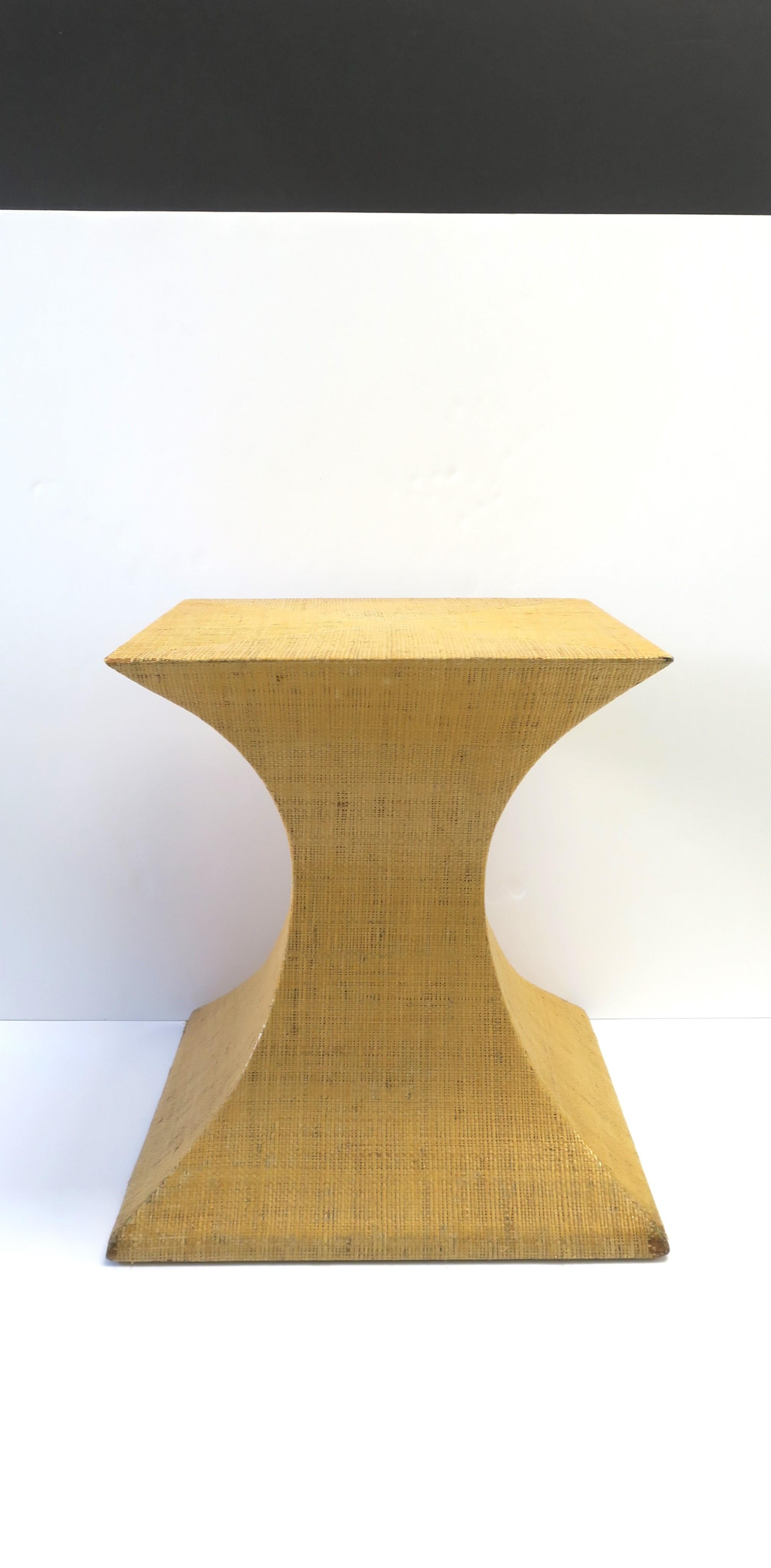 A substantial grasscloth covered pedestal table end or side table with hourglass shape, circa late-20th century. In the style of Ralph Lauren and McGuire Furniture Co. Great as a table (side/end), to hold sculpture, or as a table base. 

Dimensions: