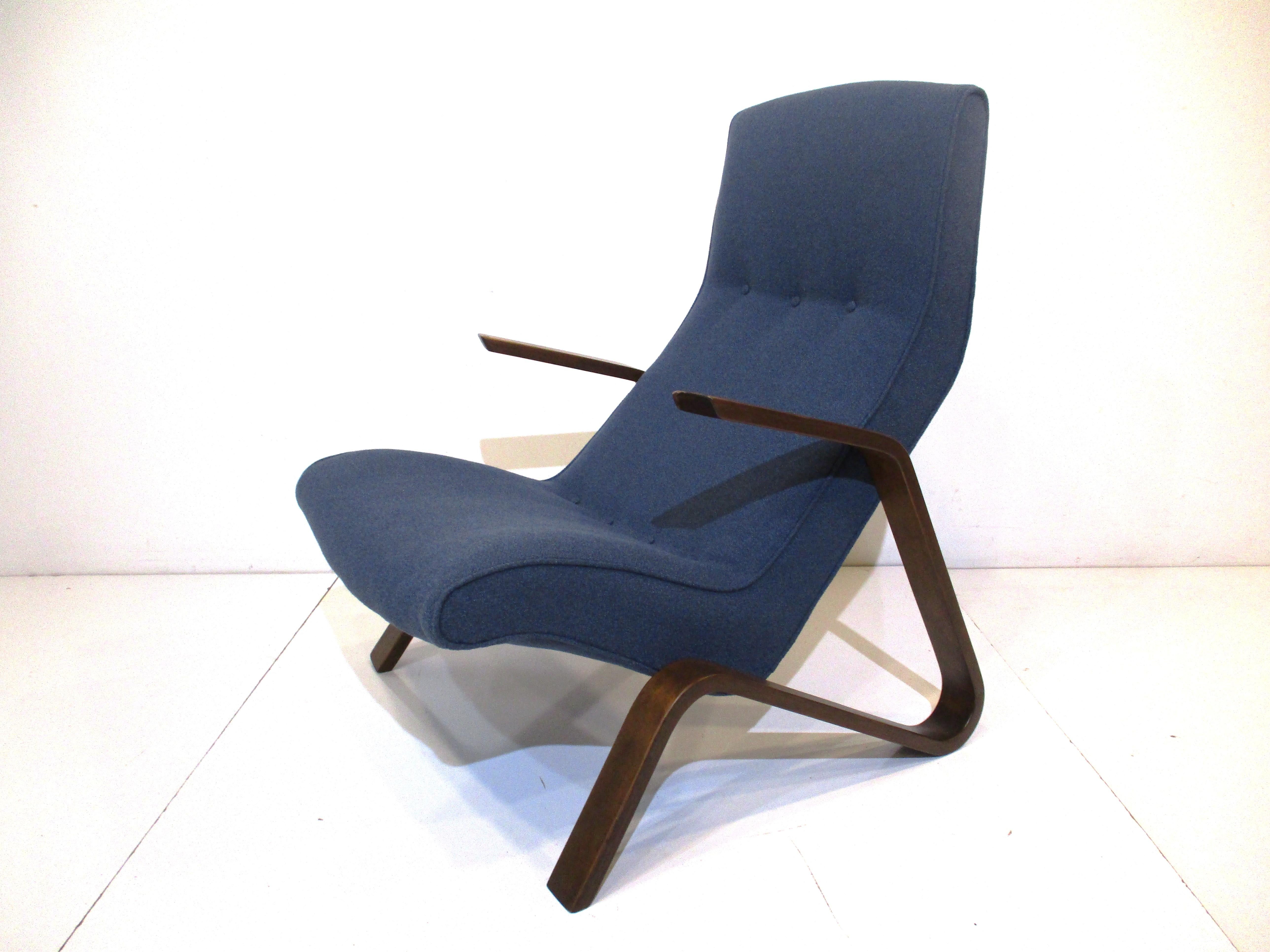 A classic vintage grasshopper lounge chair in a dark blue gray contract fabric with dark walnut toned sculptural arms and legs. This was one of the first super comfortable chairs that was intentionally ergonomically designed by artist, furniture