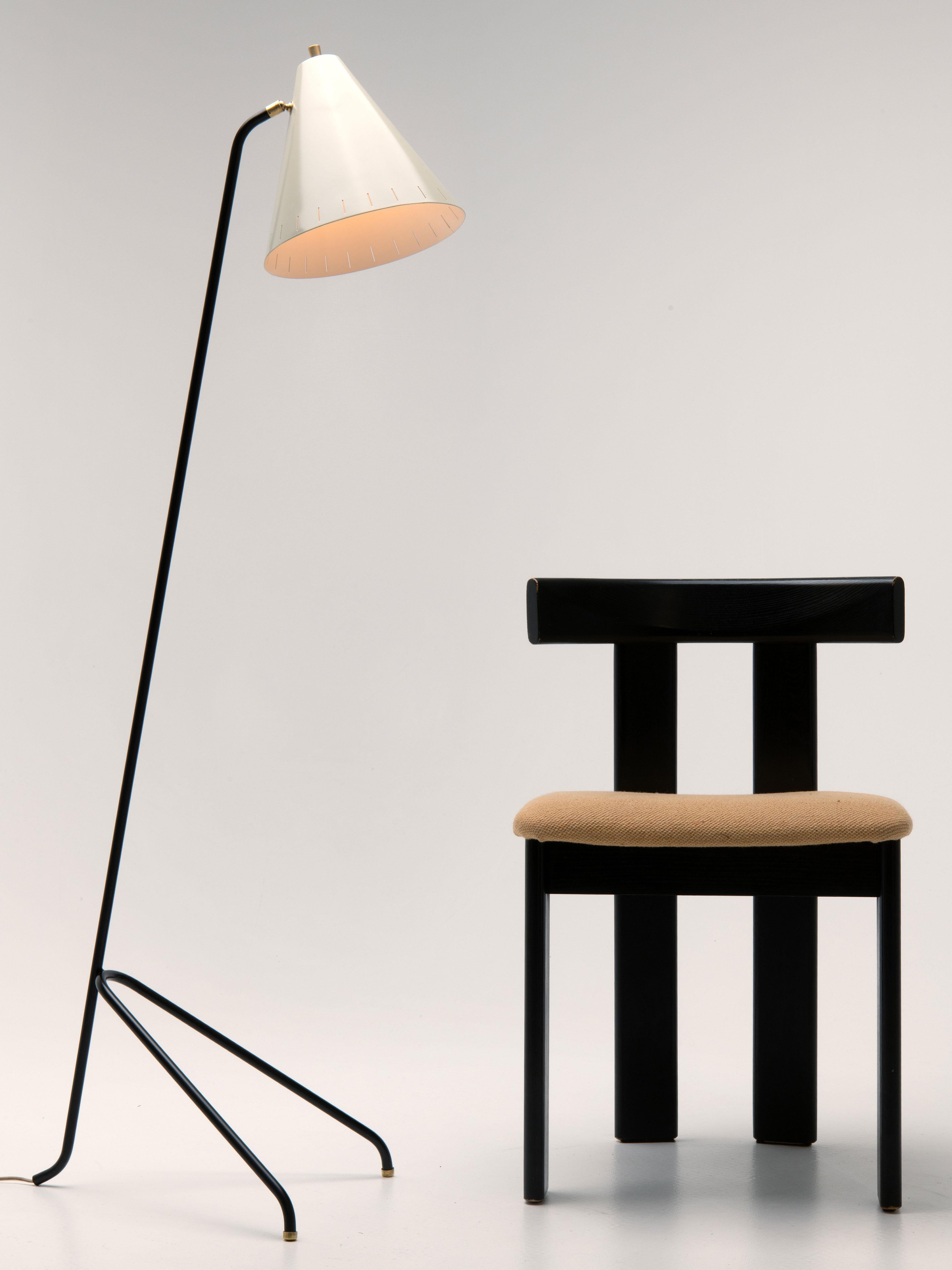 The 'Grasshopper' floor lamp consists of a perforated metal lamp shade and three ‘hairpin’ legs with brass details. The lamp shade is adjustable according to the user’s wish, making this design as stylish as functional.
This particular 'Grasshopper'