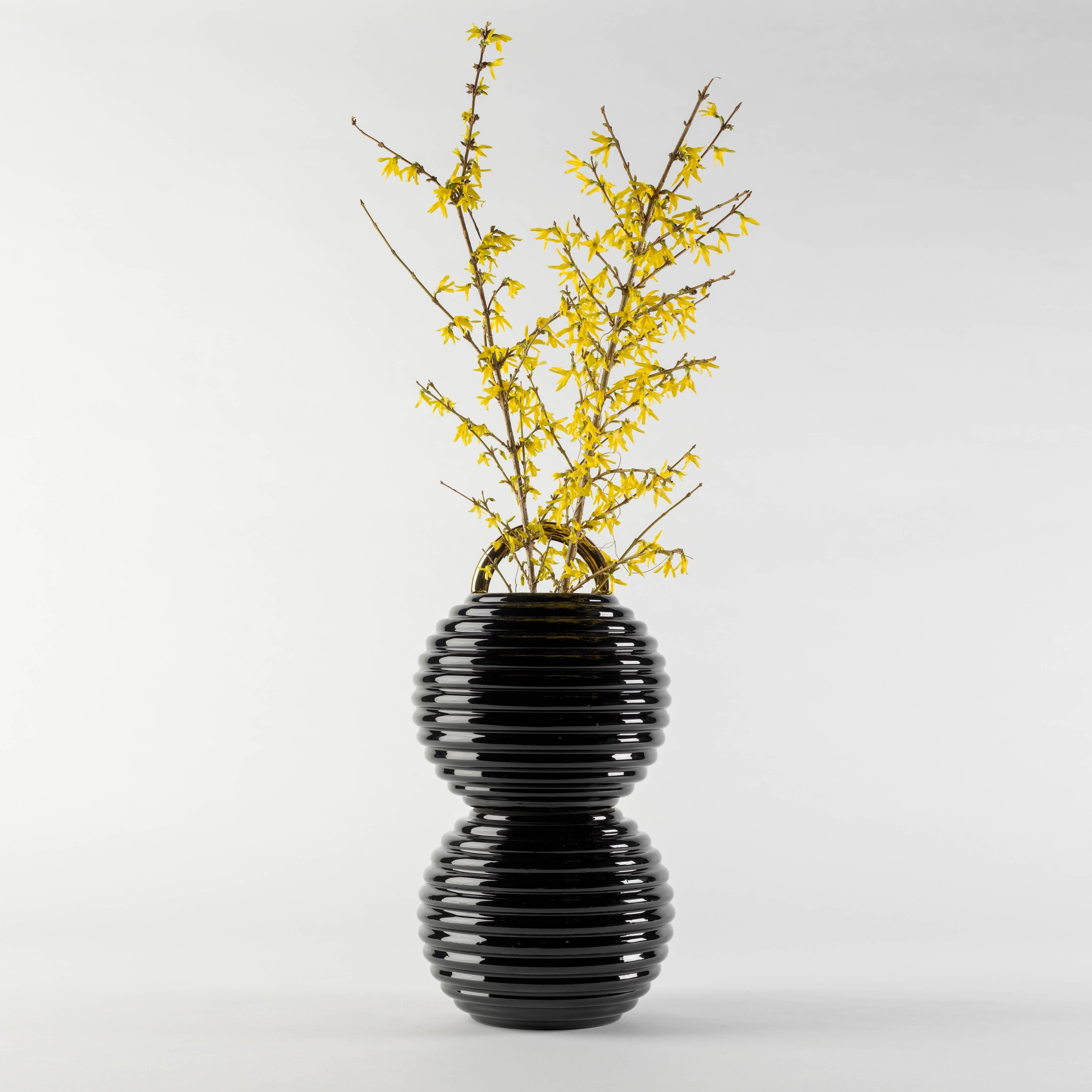 White or black enamelled ceramic vases with hand painted decorations in gold, platinum and copper.

The Grasso vases come in different finishes. The basic versions are either all in white or black with the handle painted in gold. There are also