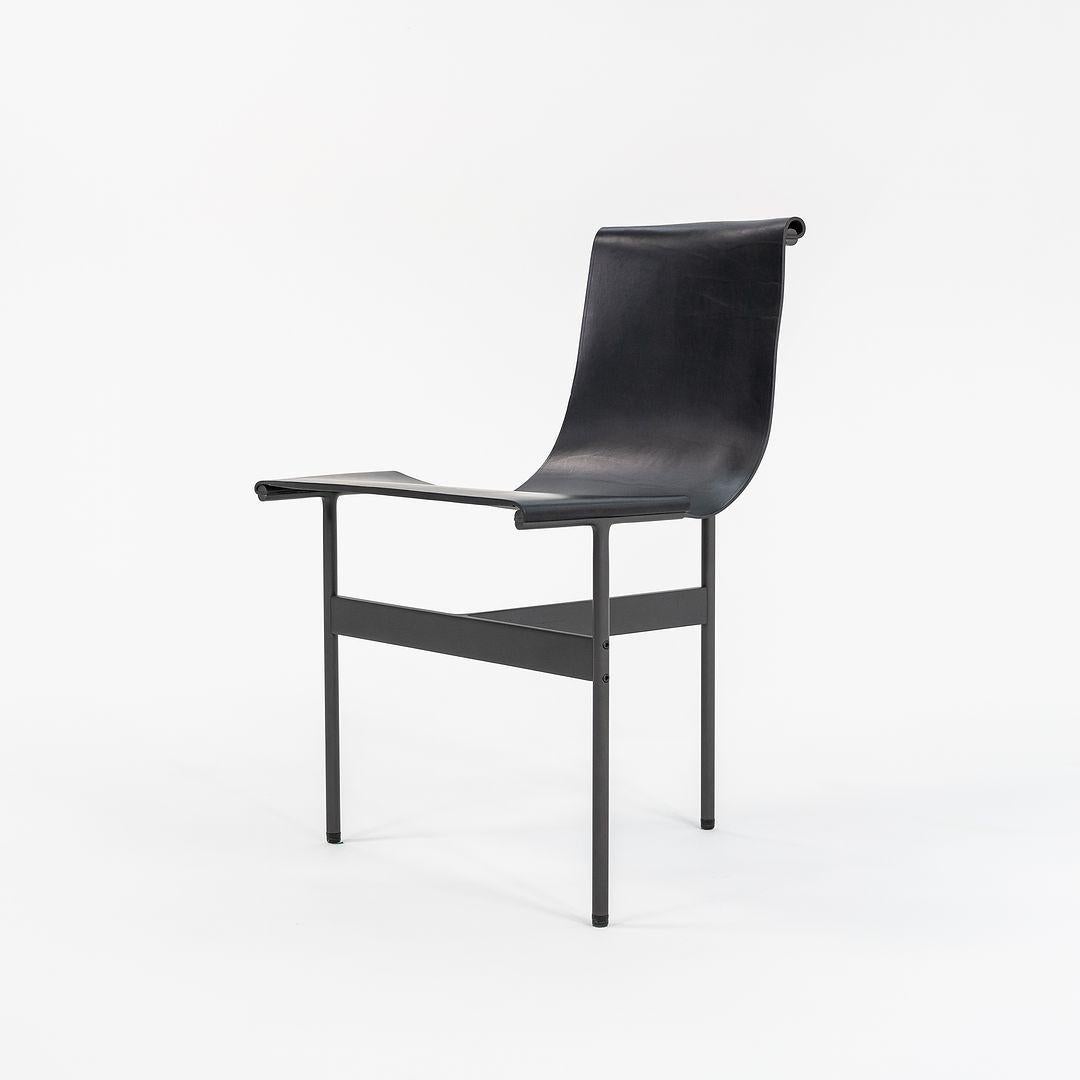 This is a TG-10 sling dining chair in black leather with a blackened frame, produced by Gratz Industries. The chair was designed by Katavolos, Littell and Kelley in 1952 as part of the original Laverne Collection produced by Gratz Industries,