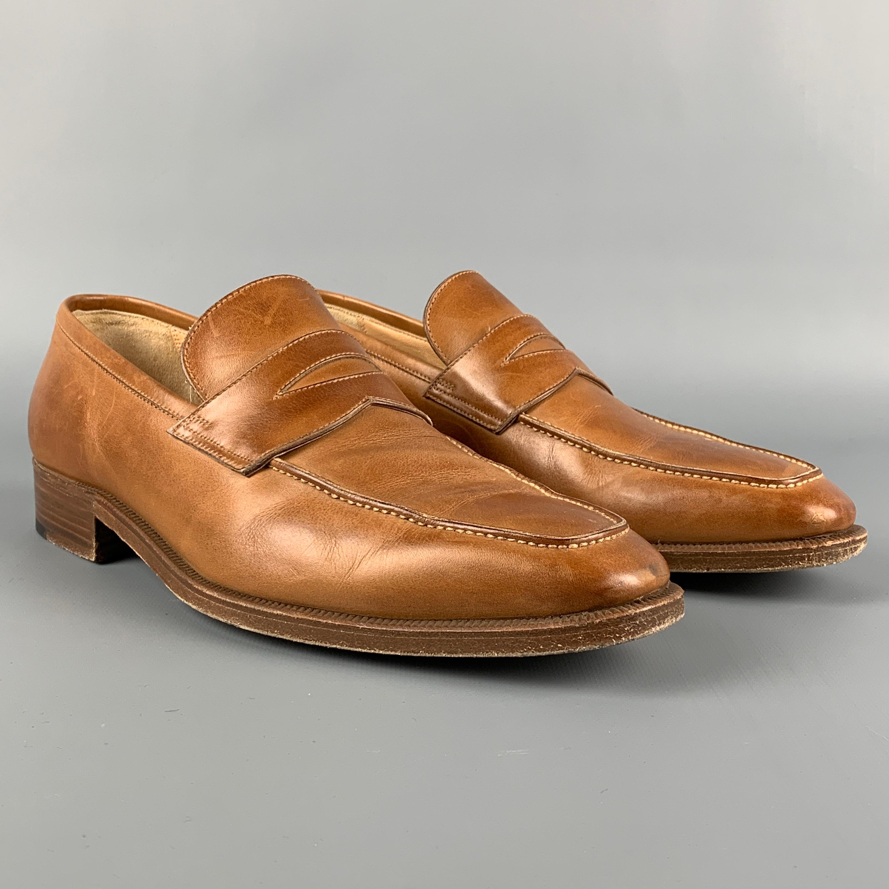 GRAVATI for WILKES BASHFORD loafers comes in a tan leather featuring a penny strap, slip on, and a square toe. Made in Italy. 

Very Good Pre-Owned Condition.
Marked: 16939 8M 655

Outsole: 11.5 in. x 4 in. 