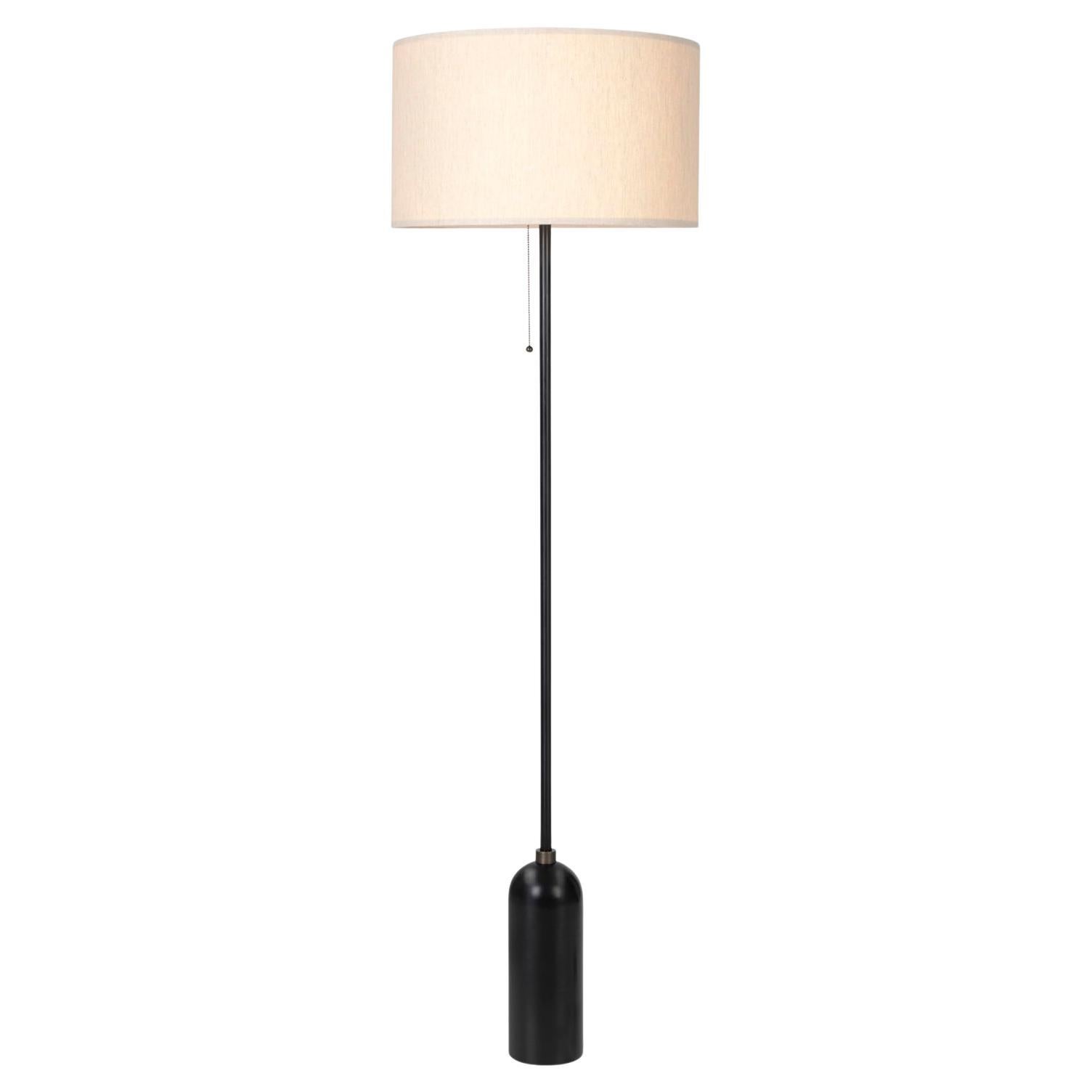'Gravity' blackened steel floor lamp for Gubi with Canvas Shade.

Executed in blackened steel with a canvas shade perched atop its stem, the Gravity Floor Lamp designed by Space Copenhagen for GUBI contrasts strength and fragility. The lamp has a