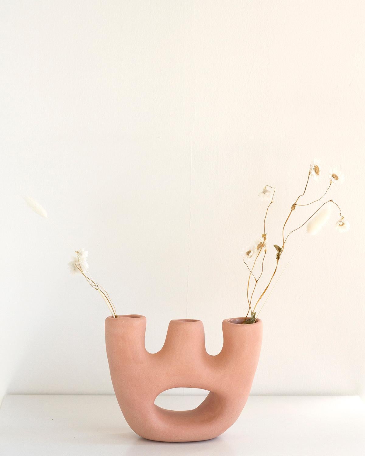 Adorn your home with this unique handmade ceramic vase. Crafted with clay and finished with a luxurious special edition pink matte glaze, its minimalist design features rustic aesthetics combined with organic modern elements. Elevate your home decor