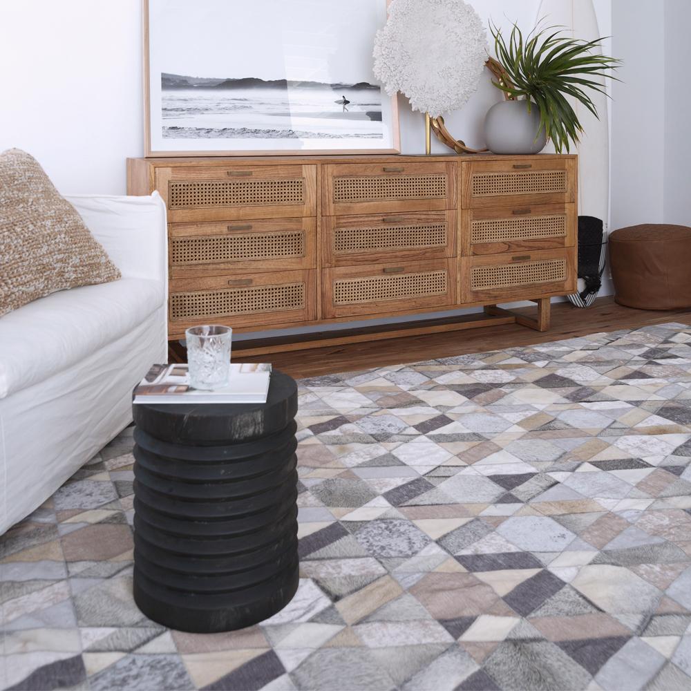 The elegant Selva rug artfully blends a mix of naturally colored premium cowhide with tonally dyed high-quality viscose. Selva’s stunning geometric pattern cohesively draws these mixed textiles together into a seamless patchwork of warm and inviting