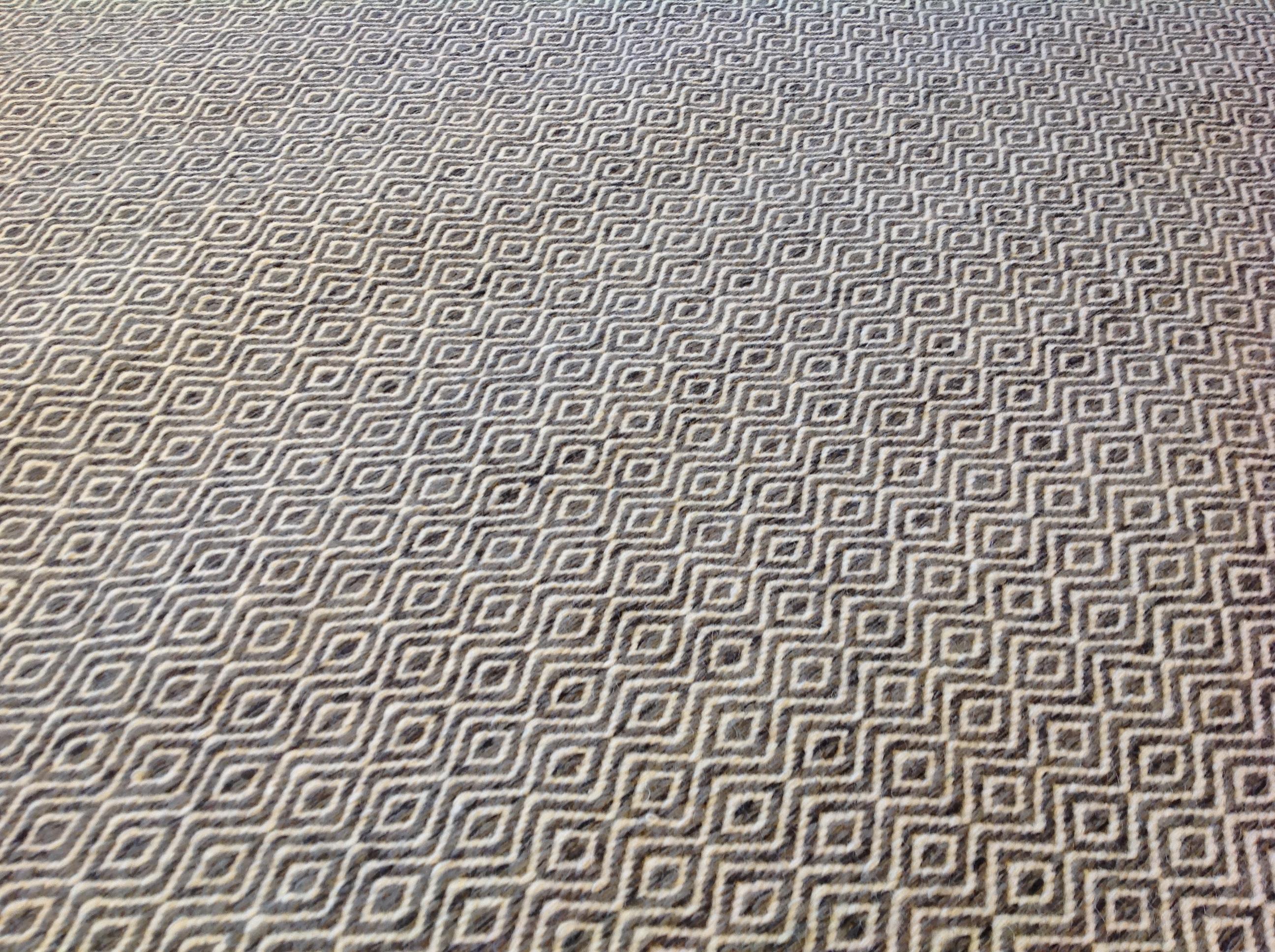 Diamonds are any space's best friend in this contemporary gray and white design. The lively geometric pattern creates a sense of movement that will complement a gray-scale palette or make colors pop! Hand knotted in India. Wool.