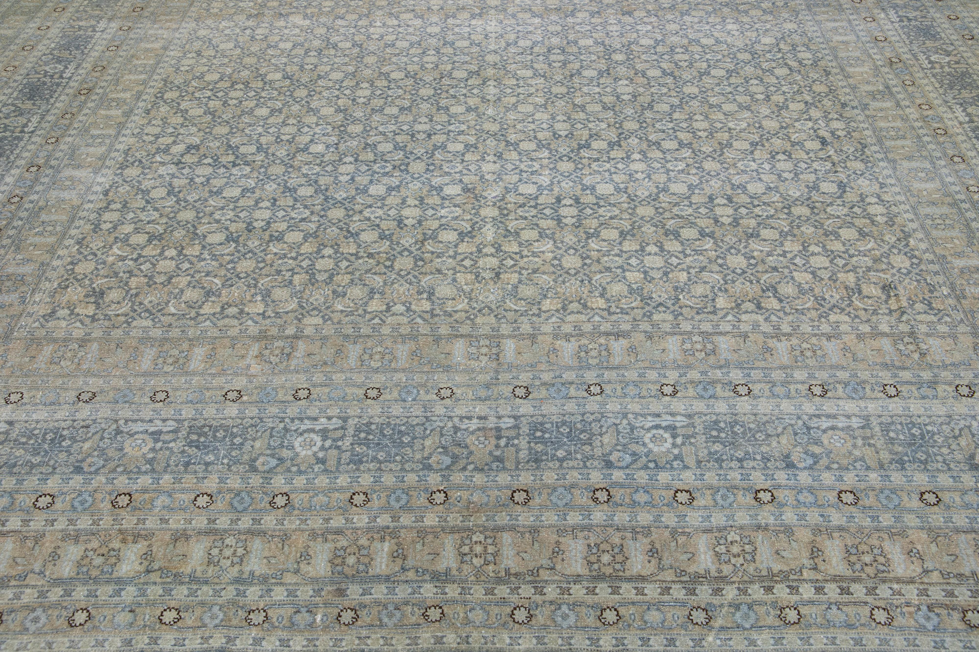 Beautiful antique Malayer hand knotted wool rug with a gray color field. This Persian rug has a gorgeous all-over floral design with blue, beige, and brown accents.

This rug measures: 11'9
