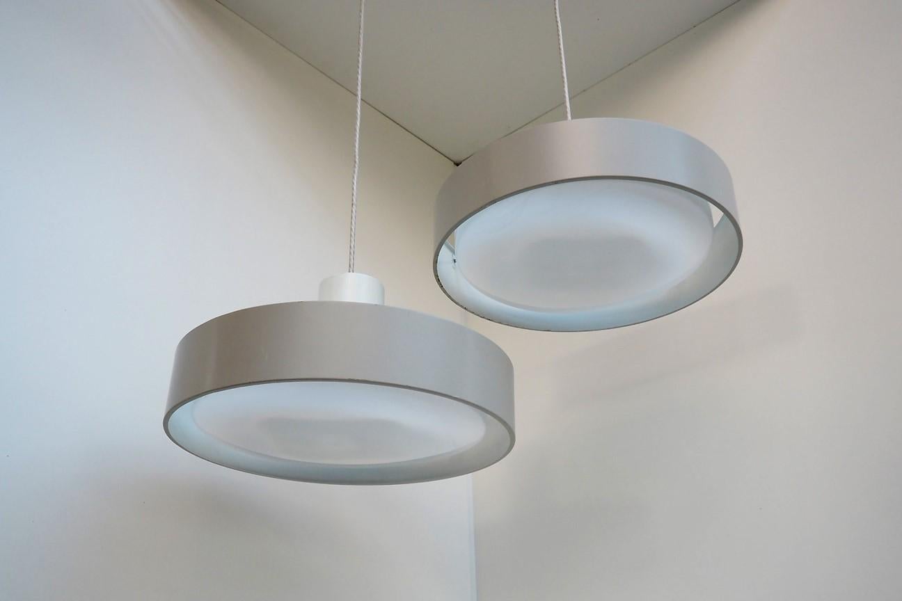Gray pair of pendants designed by Karen & Ebbe Clemmensen and Jørgen Bo for Fog & Mørup in the 1960s - the pendant is called Blaagaard (Blågård).

The streight lines gives a cool and modern expression, and the illumination is really good - it