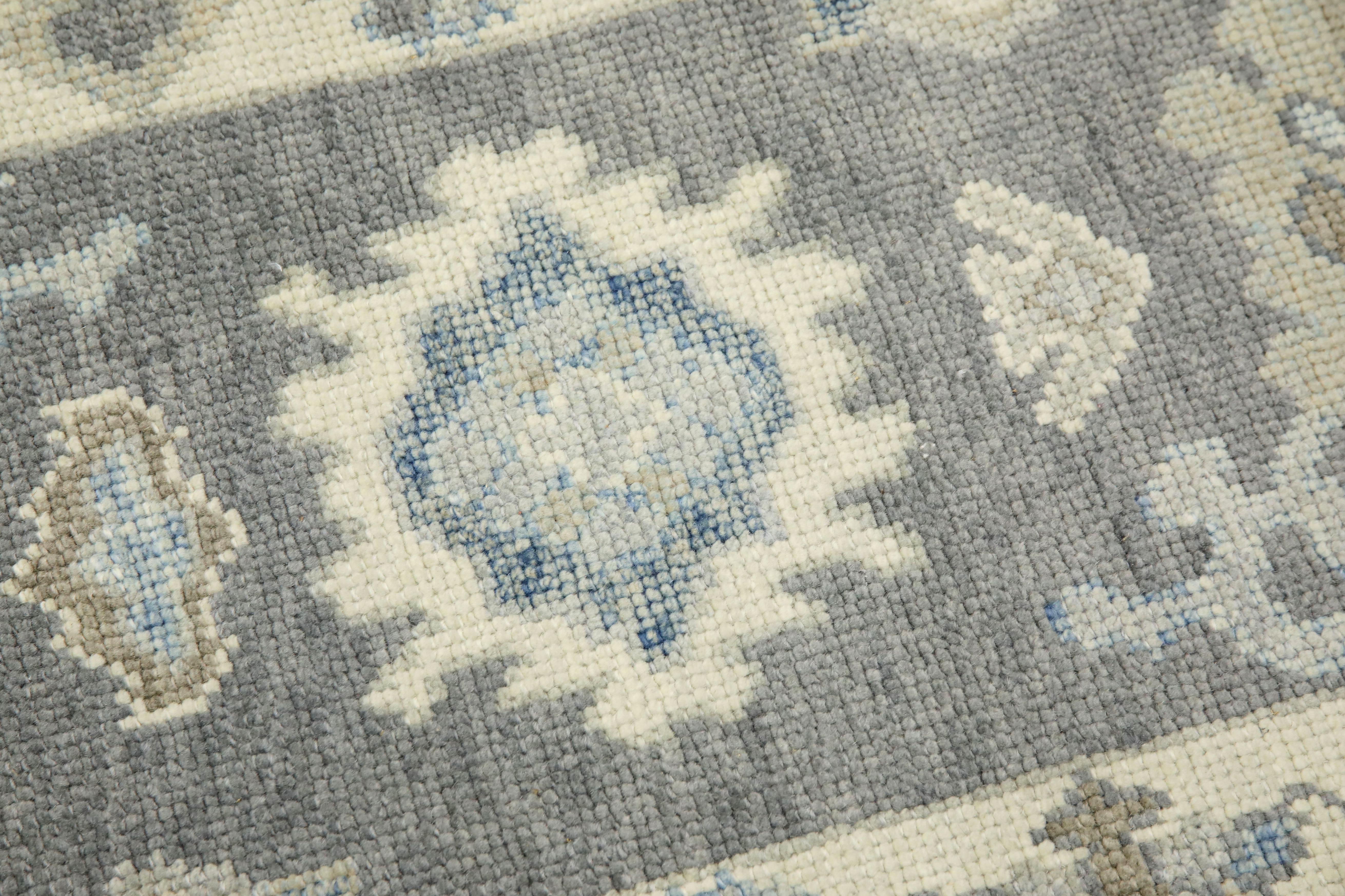 This modern Turkish Oushak rug is a stunning piece of art that has been handwoven using traditional techniques by skilled artisans. The rug features intricate patterns and a soft color palette that is achieved through the use of natural vegetable