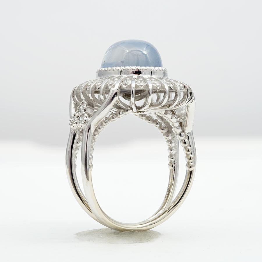 This ring is a radiant tribute to the sun itself. Its design, with diamonds extending like the sun's warm rays, is a visual masterpiece. At its heart lies a stunning cabochon star sapphire, weighing an impressive 10.06 carats, displaying an even