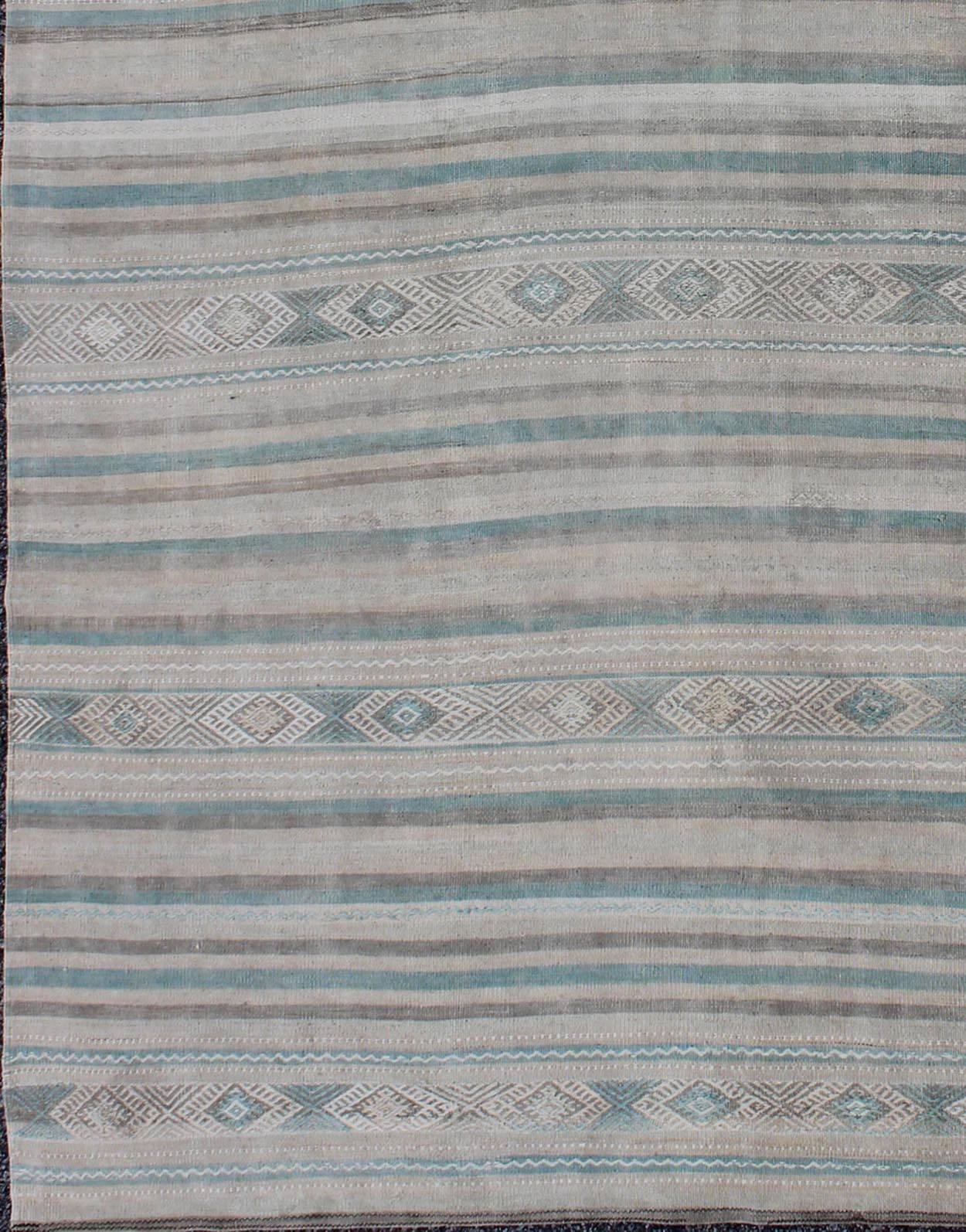 Geometric stripe design vintage Kilim rug from Turkey in gray, blue-green, taupe, camel, rug en-141148, country of origin / type: Turkey / Kilim, circa 1950

Featuring a horizontal stripe design rendered in geometric shapes, this unique midcentury