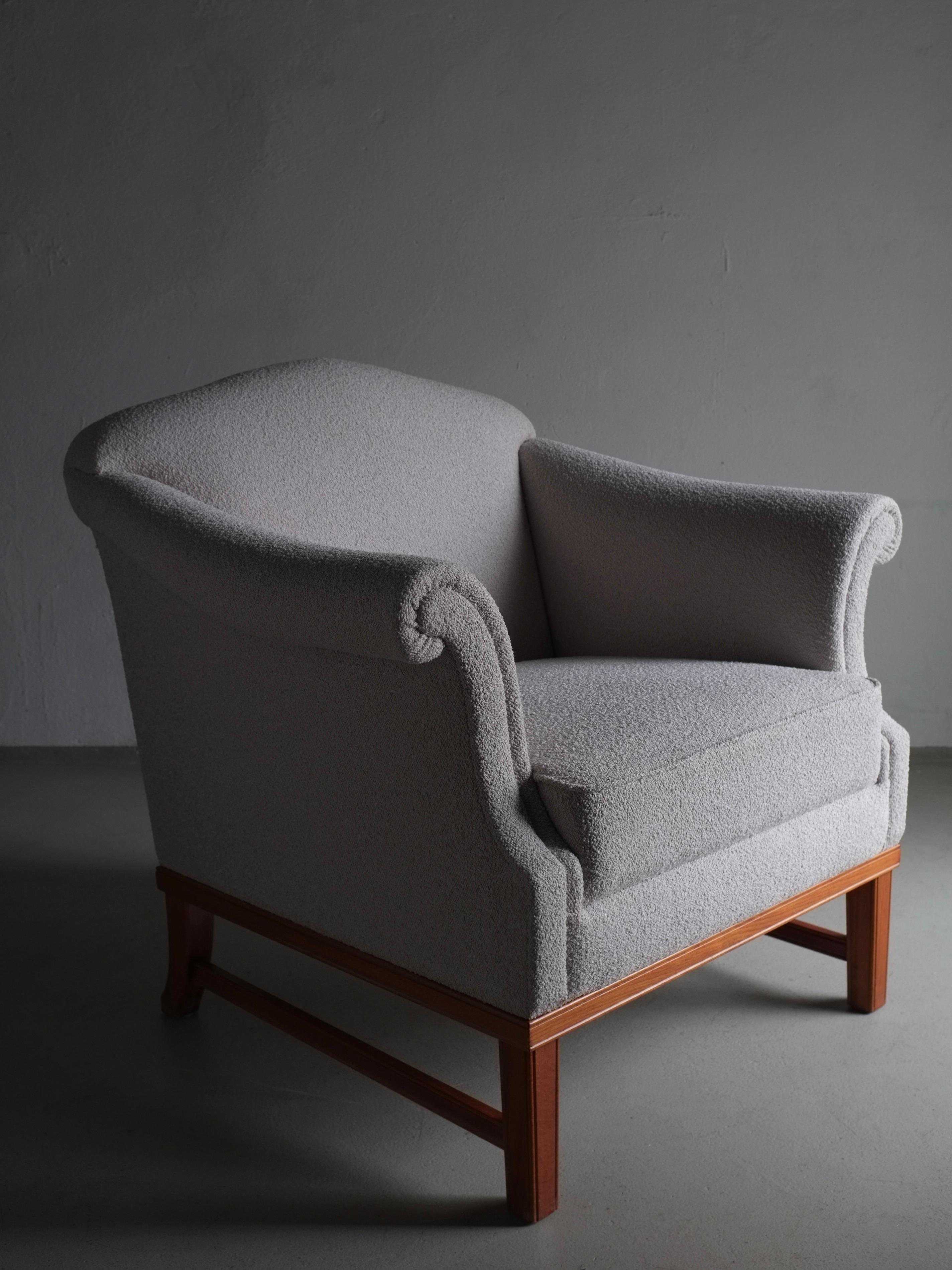 Pearl gray lounge chair with a carved back detail and wooden frame, newly upholstered with Dedar boucle fabric. I have two chairs in navy and one in pearl gray.

Additional information:
Country of manufacture: Sweden
Period: 1940s
Dimensions: W 83