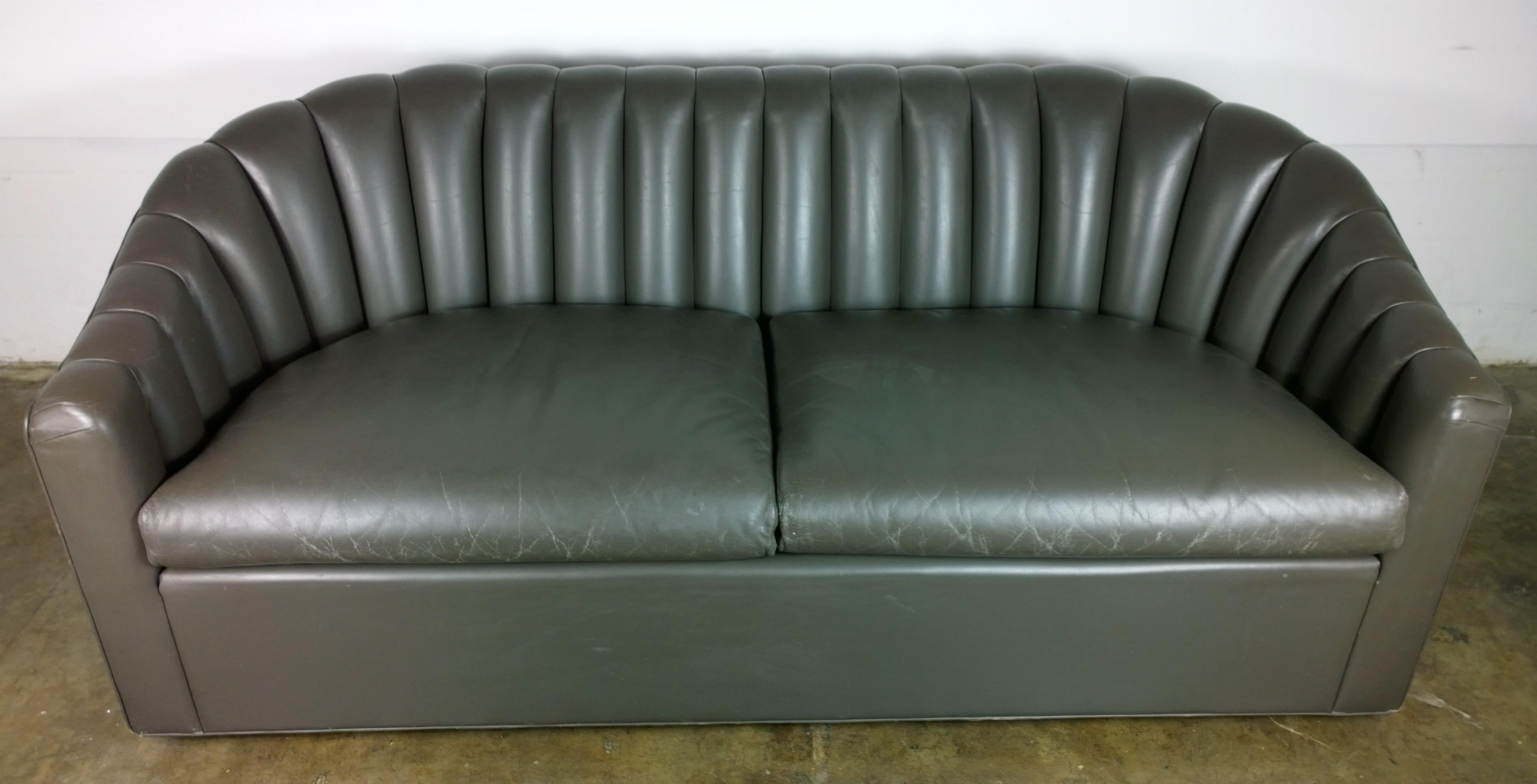 Offered is a Mid-Century Modern signed Jack Lenor Larson, Ward Bennett style beautiful and elegant grayish brown (milk chocolate) channel back leather two-cushion seat petite sofa or loveseat. The leather has a very rough hewn Ralph Lauren look.
