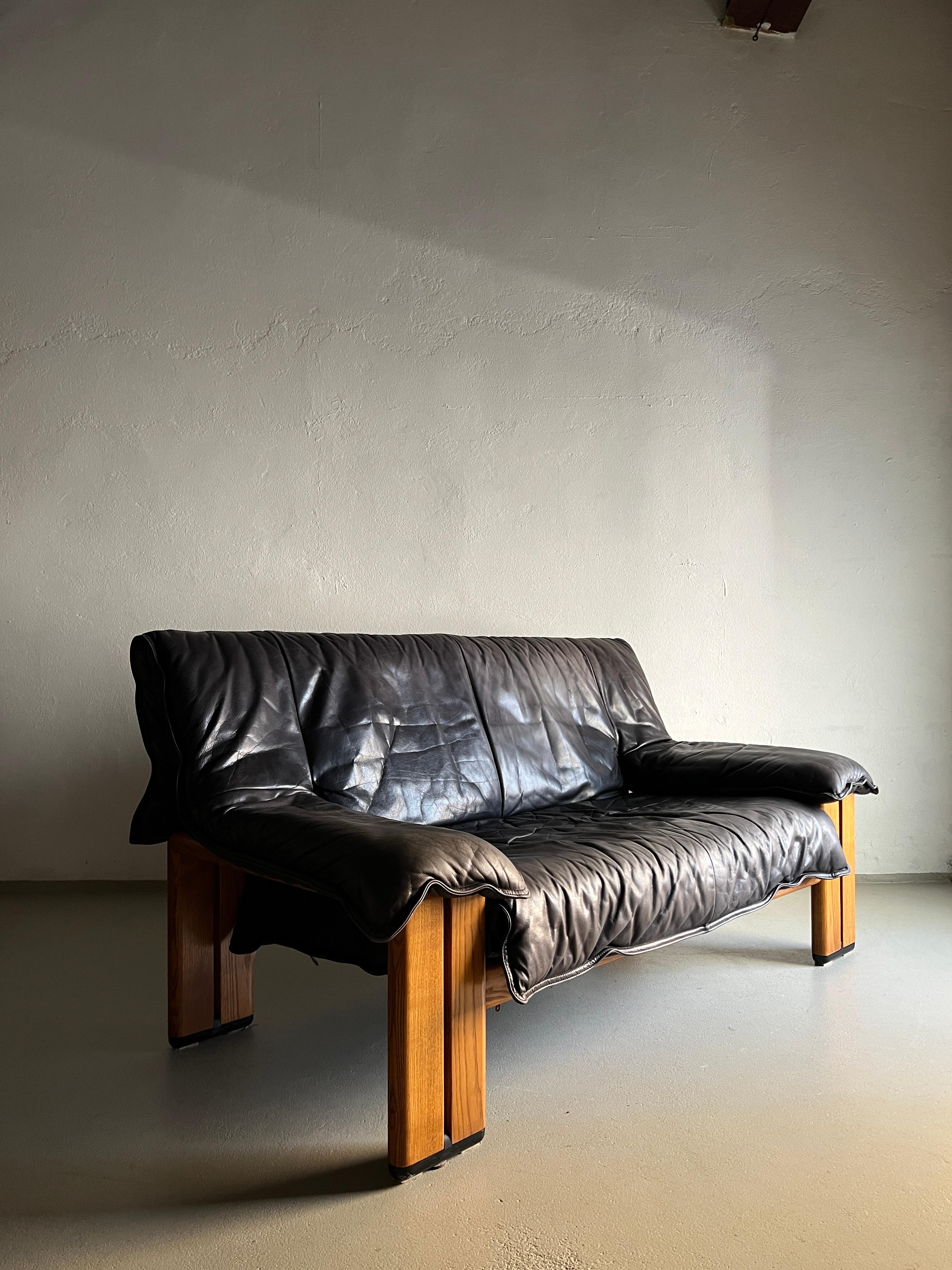 Vintage 2-seater sofa made of high-quality gray (faded black) buffalo leather with solid pine (I suppose) wood legs. Very comfortable.

Additional information:
Production period: 1990s
Dimensions: 158 W x 82 D x 80 H cm
Seat: 38 H cm
Condition: good