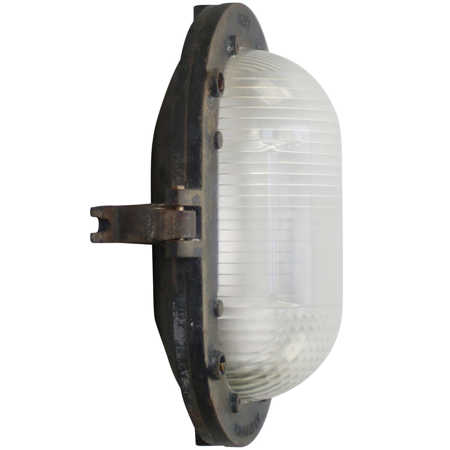 French Industrial wall / ceiling lamp by Holophane, France
Grey cast iron with frosted cut glass.

Weight : 8.20 kg / 18.1 lb

Priced per individual item. All lamps have been made suitable by international standards for incandescent light bulbs,