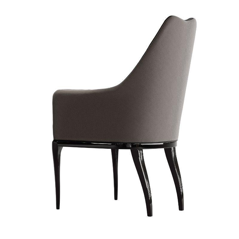 Sumptuous and elegant yet simple and clean, this exquisite chair will make a stunning head of the table or an exquisite addition to a living room decor. Upholstered with a splendid gray fabric, it is made of polished black-lacquered wood. Please