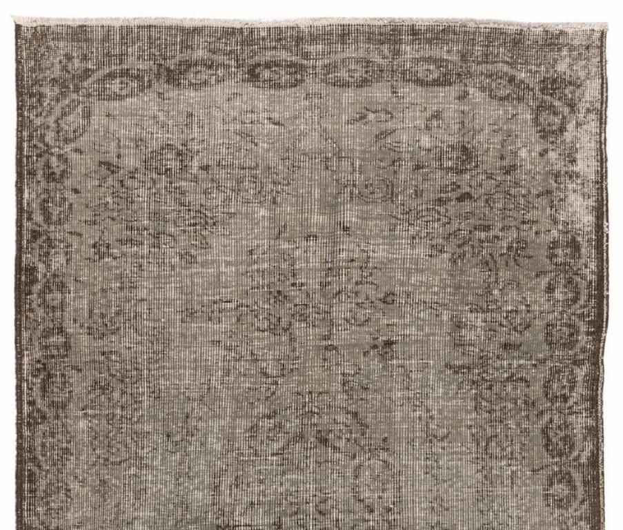 A vintage Turkish area rug re-dyed in gray color for contemporary interiors.
Finely hand knotted, low wool pile on cotton foundation. Professionally washed.
Sturdy and can be used on a high traffic area, suitable for both residential and commercial