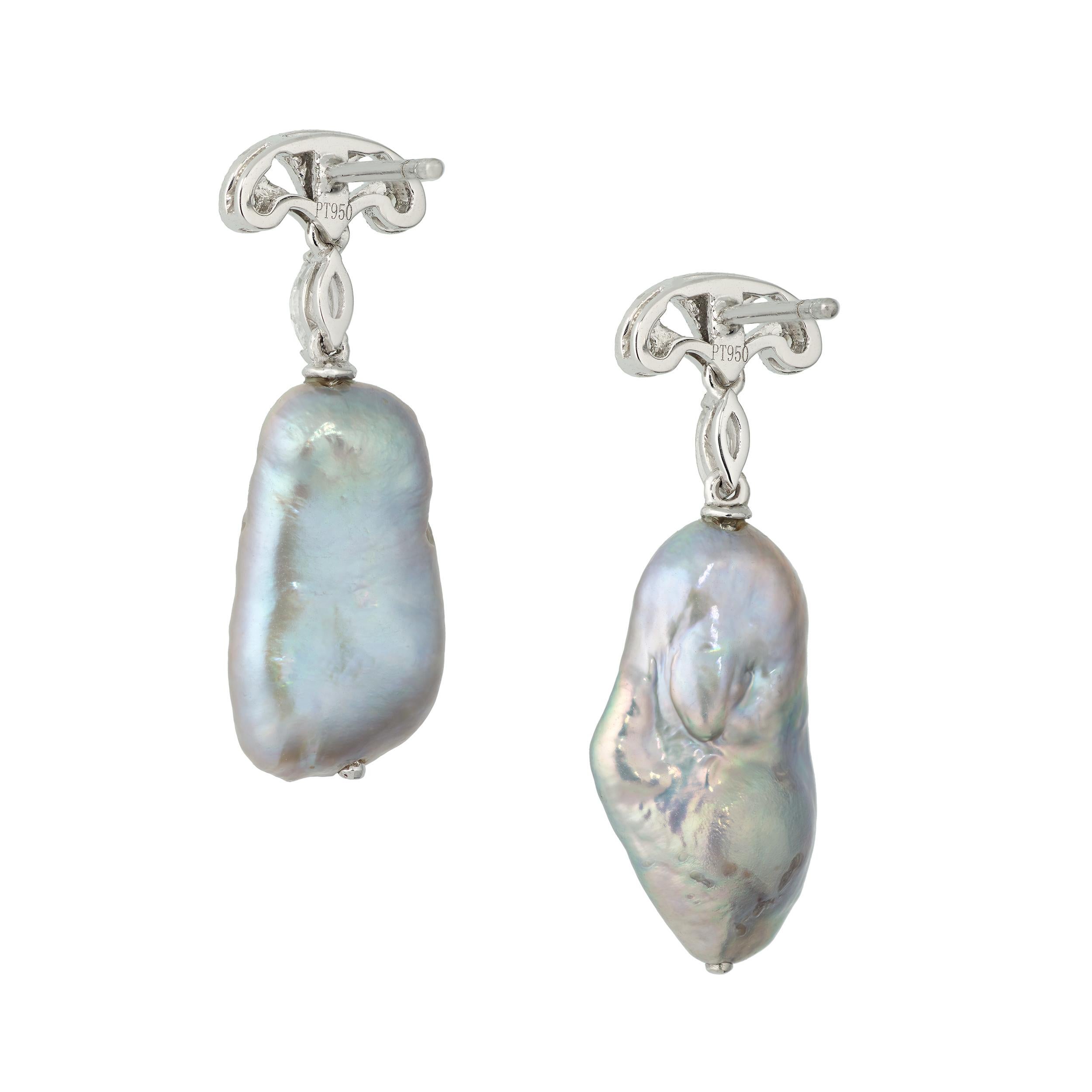 These lightweight and versatile drop earrings are suitable for most any occasion.  The gray freshwater pearls have a very lively iridescent luster.  Just above the pearl drop is a single Marquis Diamond connecting to the top of the earring with a