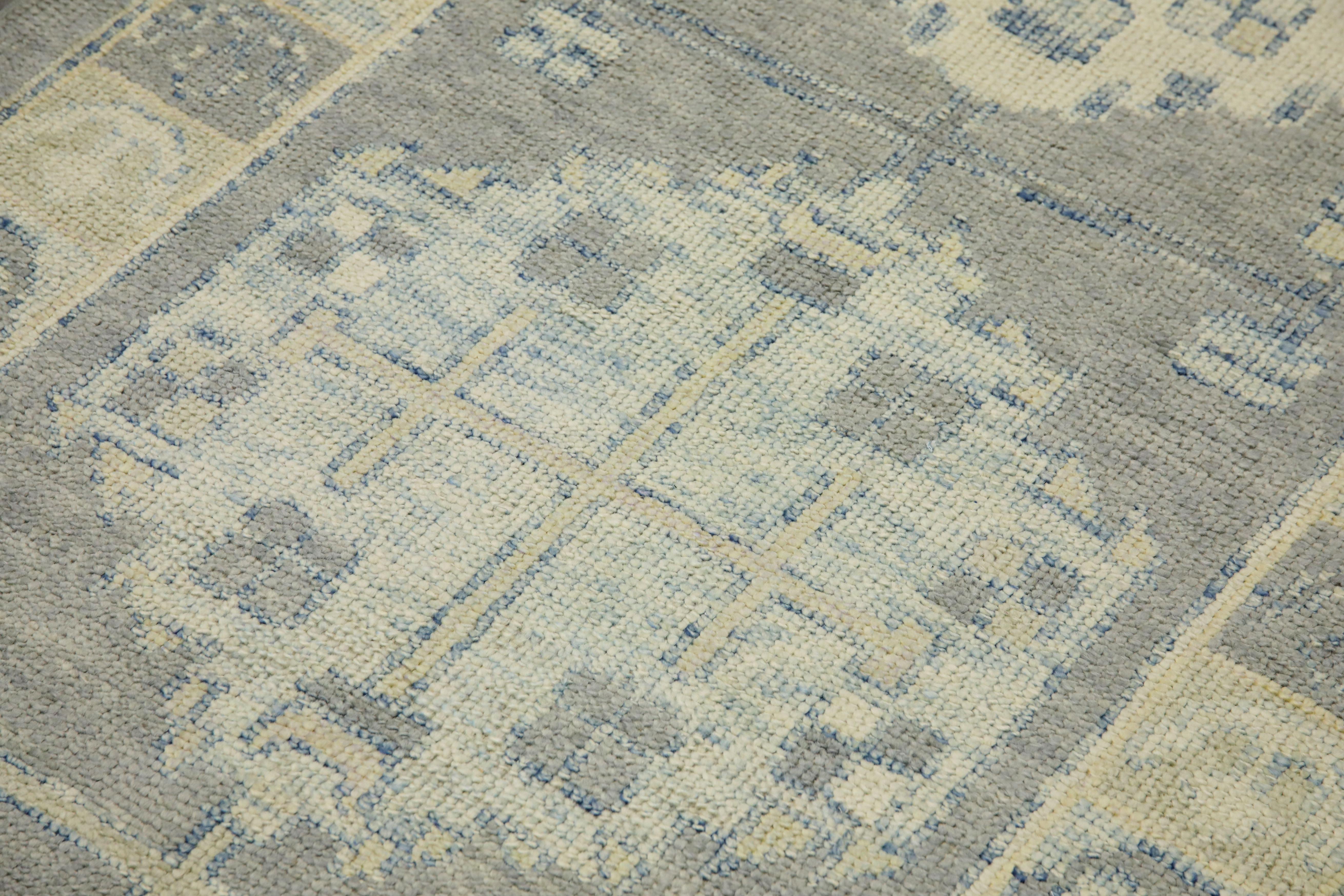 This modern Turkish Oushak rug is a stunning piece of art that has been handwoven using traditional techniques by skilled artisans. The rug features intricate patterns and a soft color palette that is achieved through the use of natural vegetable