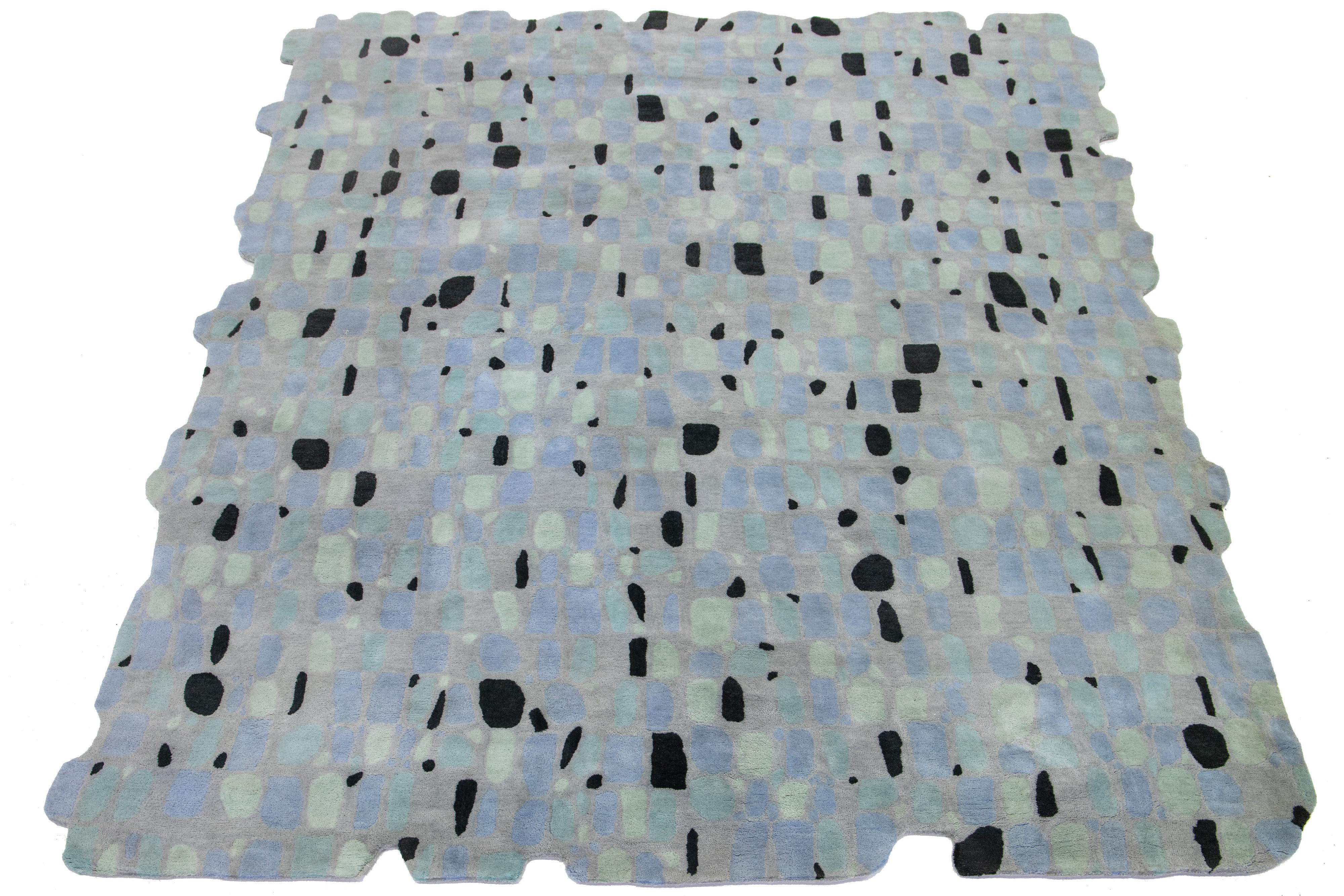 This beautiful, modern hand-tufted wool rug part of our Laura Gottwald for Apadana Collection features gray, black, blue, and green fields. This abstract design celebrates biomorphic form, as in Alvar Alto’s famous vase, Noguchi’s coffee
table,