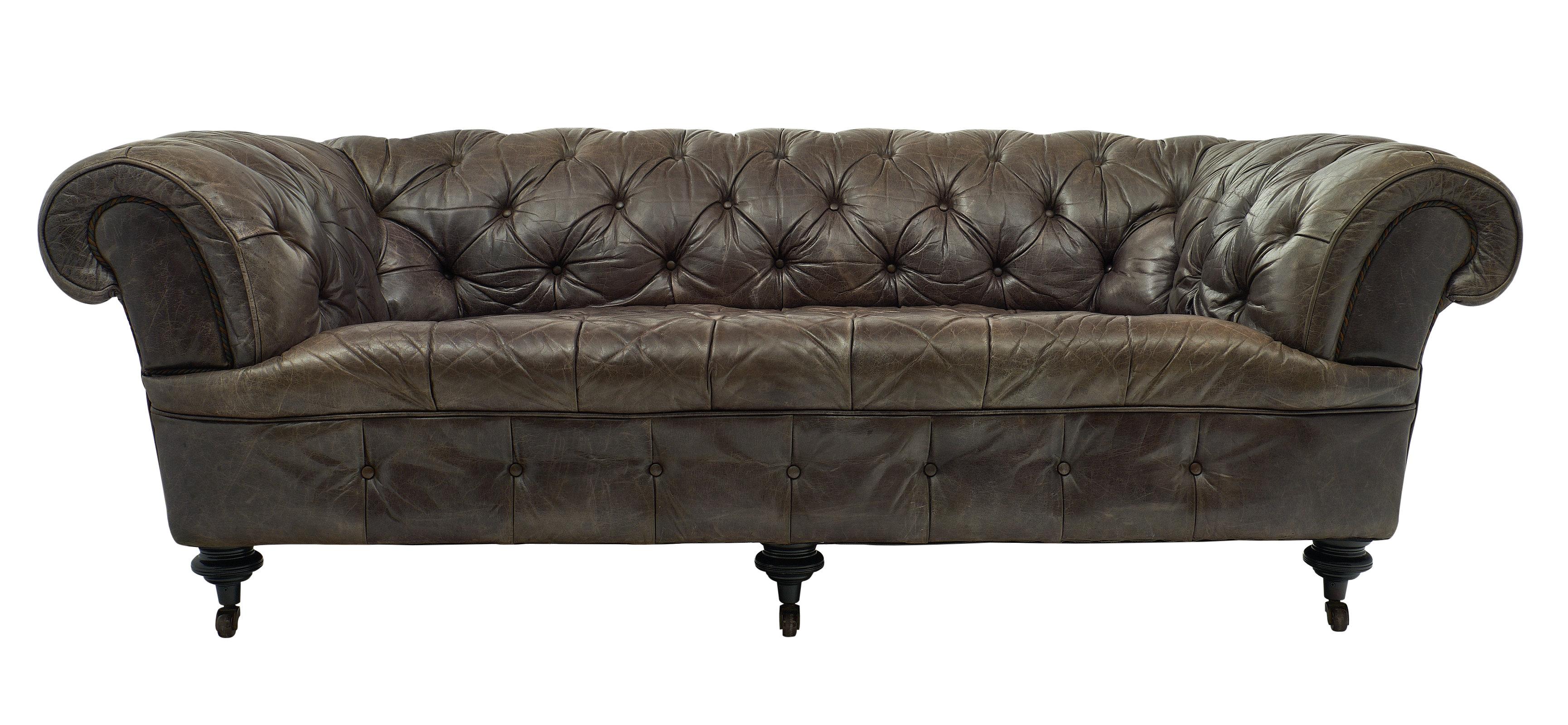 Vintage gray leather chesterfield sofa on ebonized feet with casters. We love the deep seat on this very comfortable piece, as well as the classic details.