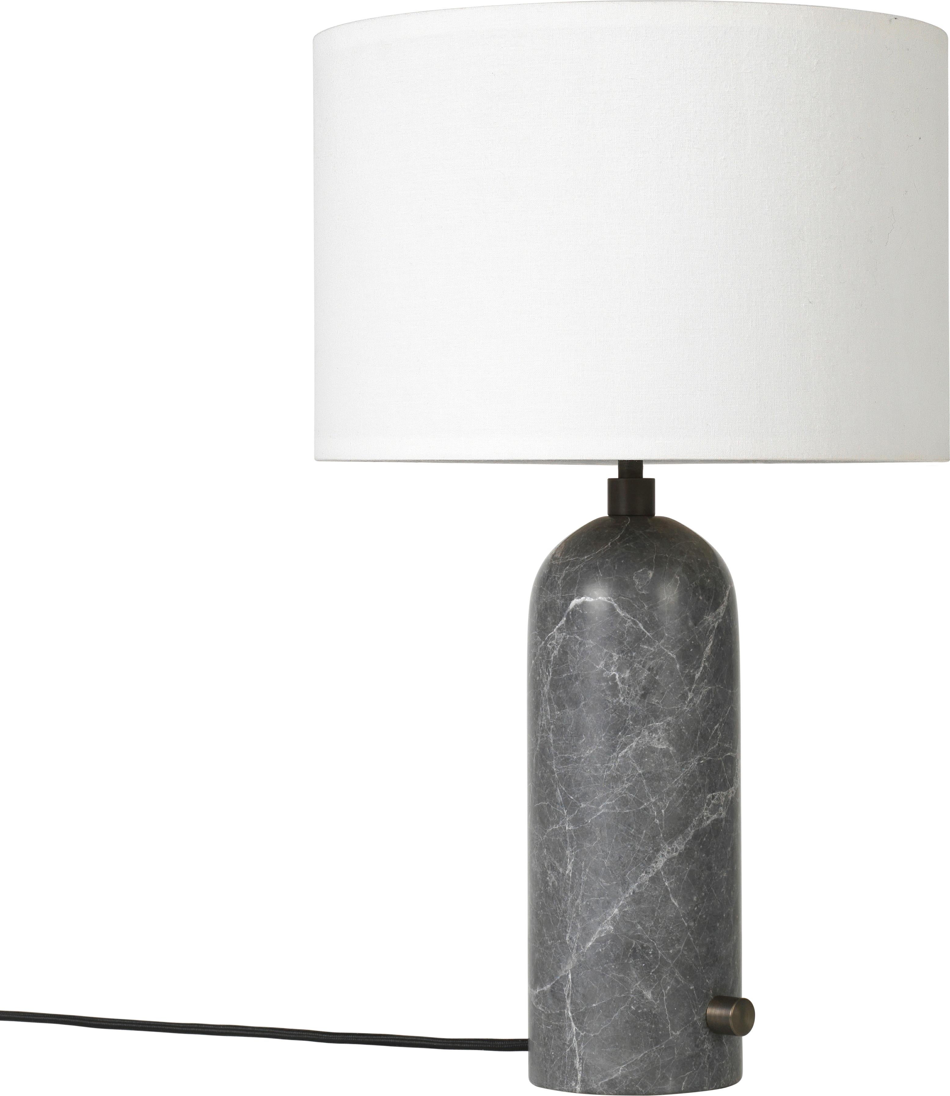 Large 'Gravity' marble table lamp by Space Copenhagen for Gubi in Gray.

Executed in solid marble with a canvas or white textile shade perched atop its stem, the Gravity table lamp designed by Space Copenhagen for GUBI contrasts strength and