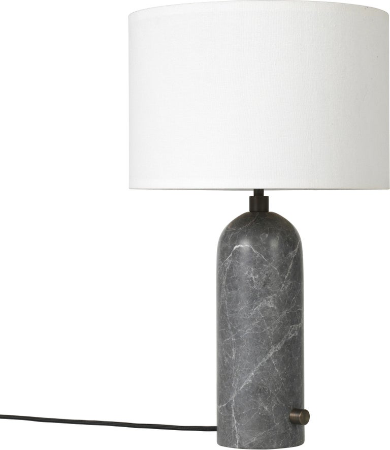 Large 'Gravity' Marble Table Lamp by Space Copenhagen for Gubi in Gray.

Executed in solid marble with a canvas or white textile shade perched atop its stem, the Gravity table lamp designed by Space Copenhagen for GUBI contrasts strength and