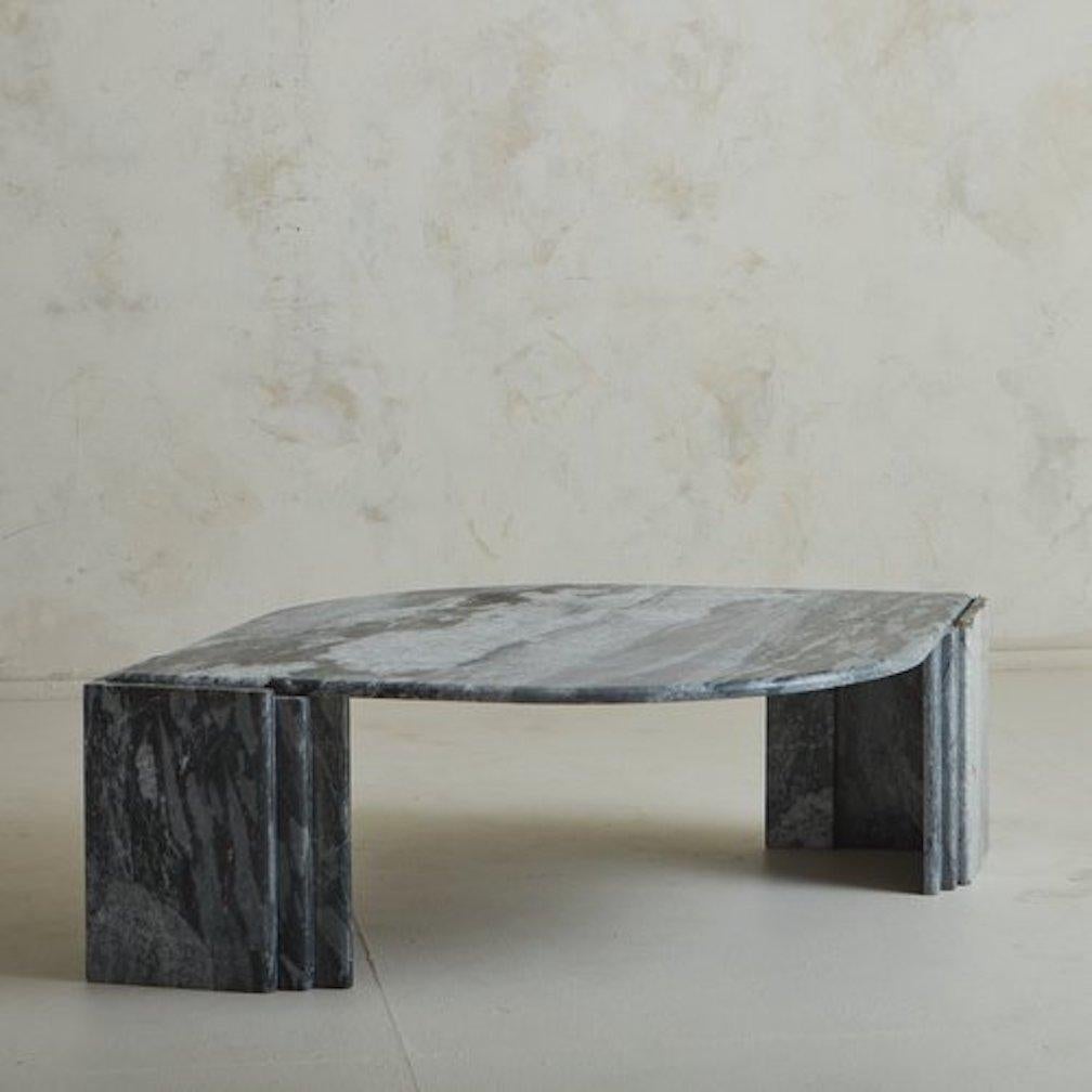 A sculptural 1970s Italian coffee table by Roche Bobois in a stunning gray marble with richly hued veining. This teardrop shaped table is supported by two triangular pedestal legs, which are segmented in vertical tiers. Unmarked. Sourced in Italy,