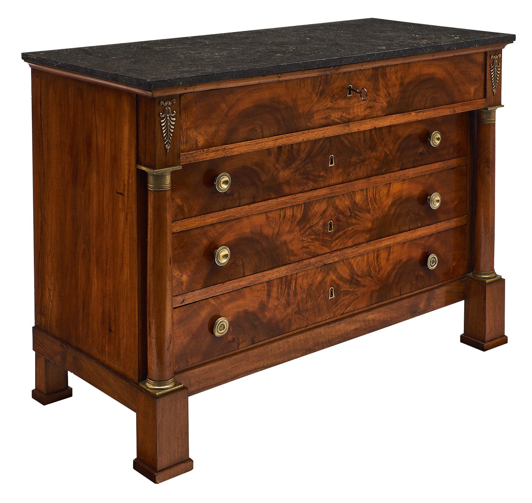 French Empire period chest with grey marble top. It is made of solid walnut and burled walnut in excellent antique condition. This impeccable period commode features detached columns, decorative bronzes, and the original dark grey intact marble