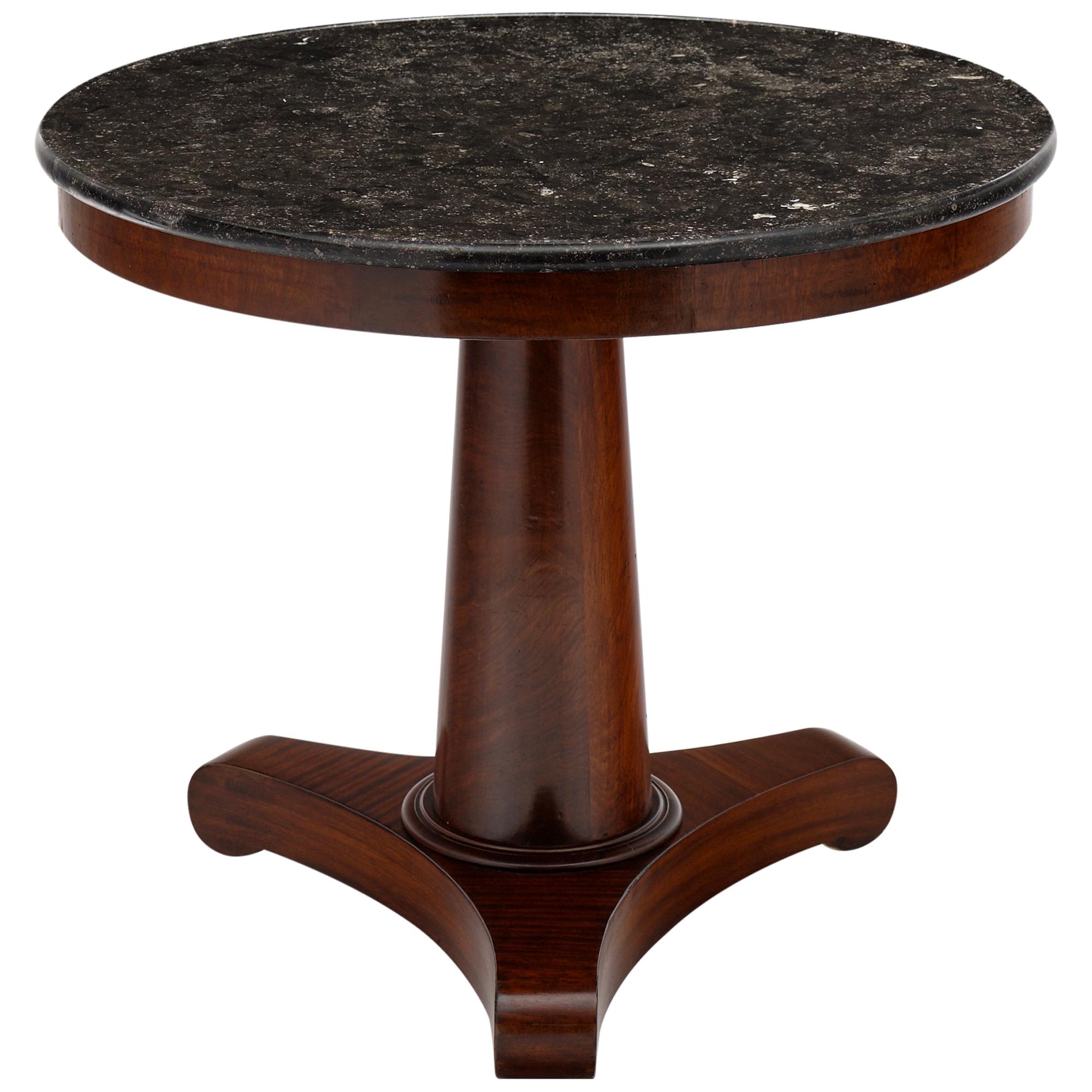 Gray marble topped Empire style gueridon with a beautiful mahogany base. The dark color of the marble is very elegant; and the French polish finish of the base adds a sophisticated luster. We love the classic style and elegant details. The marble