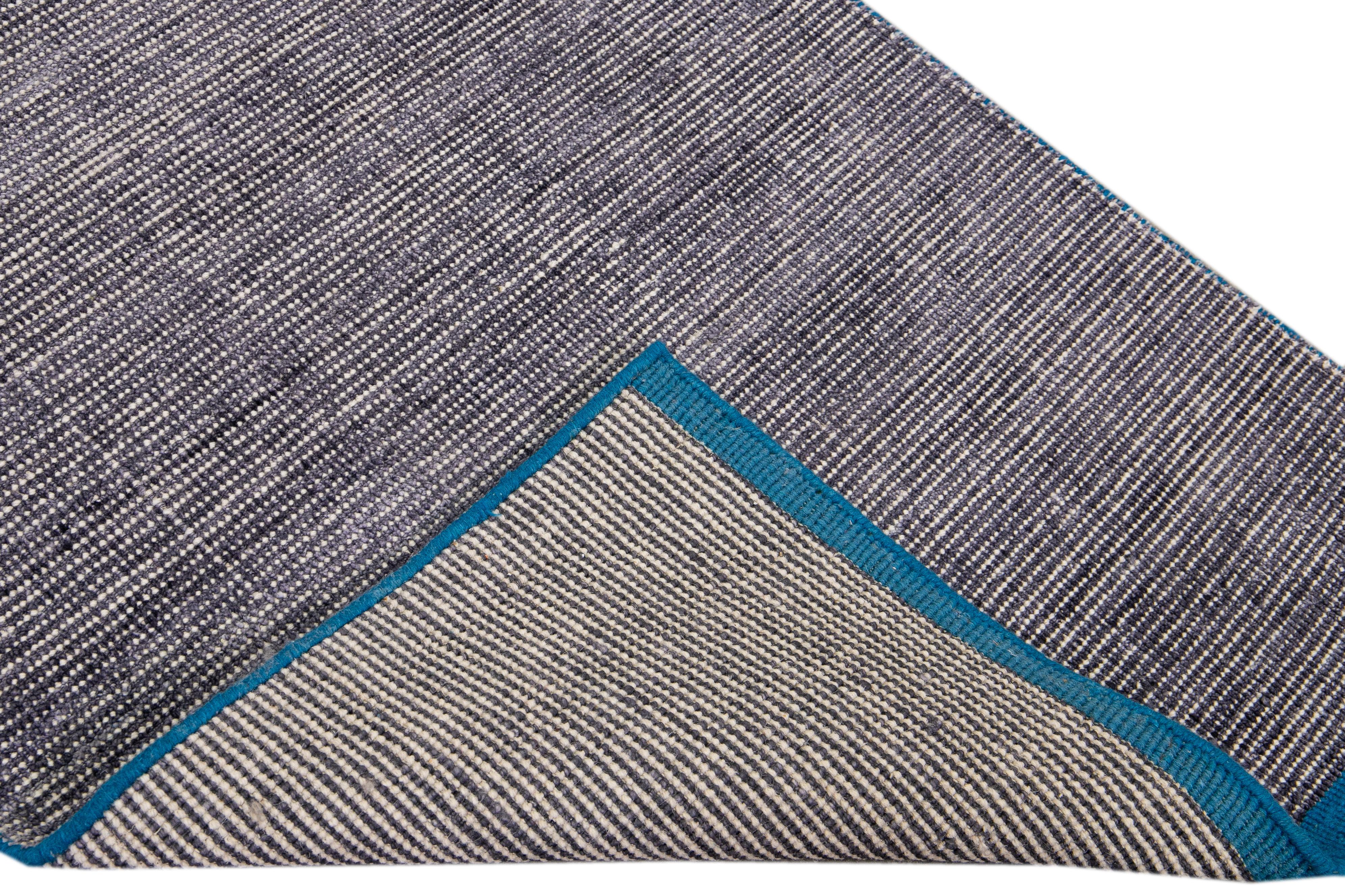 Beautiful modern Handmade Indian bamboo and silk boho rug with a gray field. This Groove Collection Rug has a teal frame in an all-over solid design.

This rug measures: 3'0