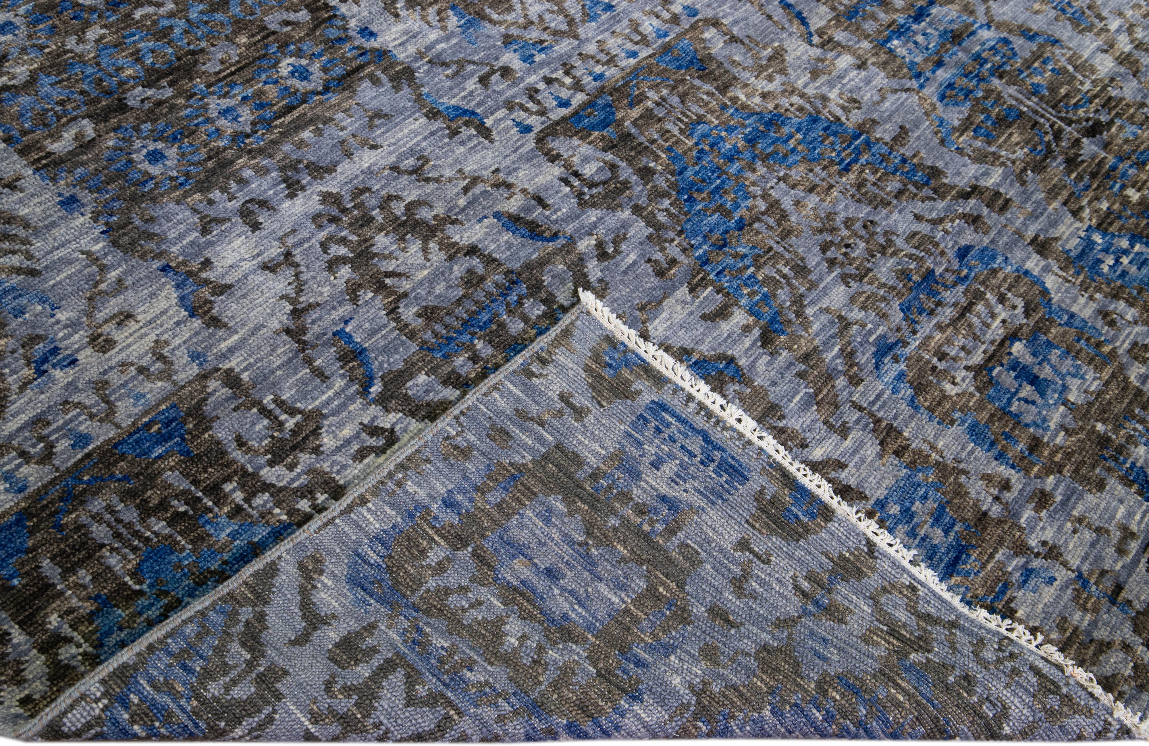 Schöner handgefertigter Wollteppich mit einem grauen Feld. Dieser moderne Teppich hat einen blauen und braunen Akzent mit einem wunderschönen All-Over-Muster.

Dieser Teppich misst: 12'2 Zoll