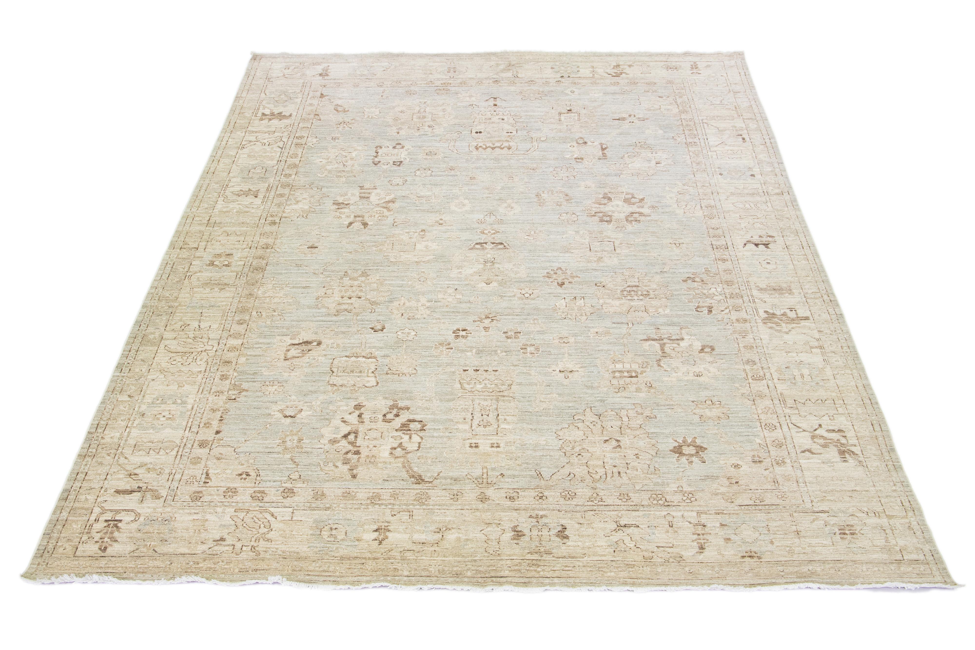 Beautiful modern Oushak hand-knotted wool rug with a gray color field. This Piece has beige and brown accent colors in a gorgeous all-over floral design.

This rug measures: 9'10