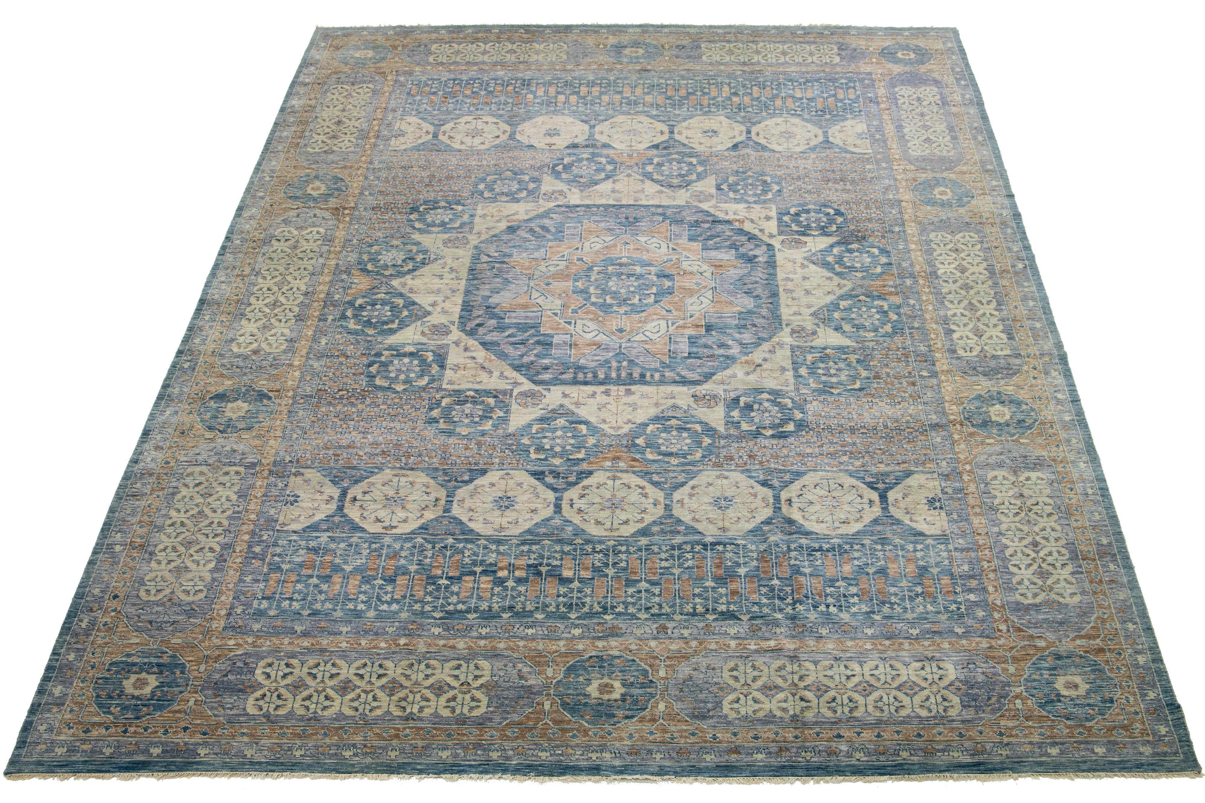 A Mamluk wool rug in a gray field with allover floral designs. This hand-knotted modern piece has blue and beige accents that complement the design.

This rug measures 16'7