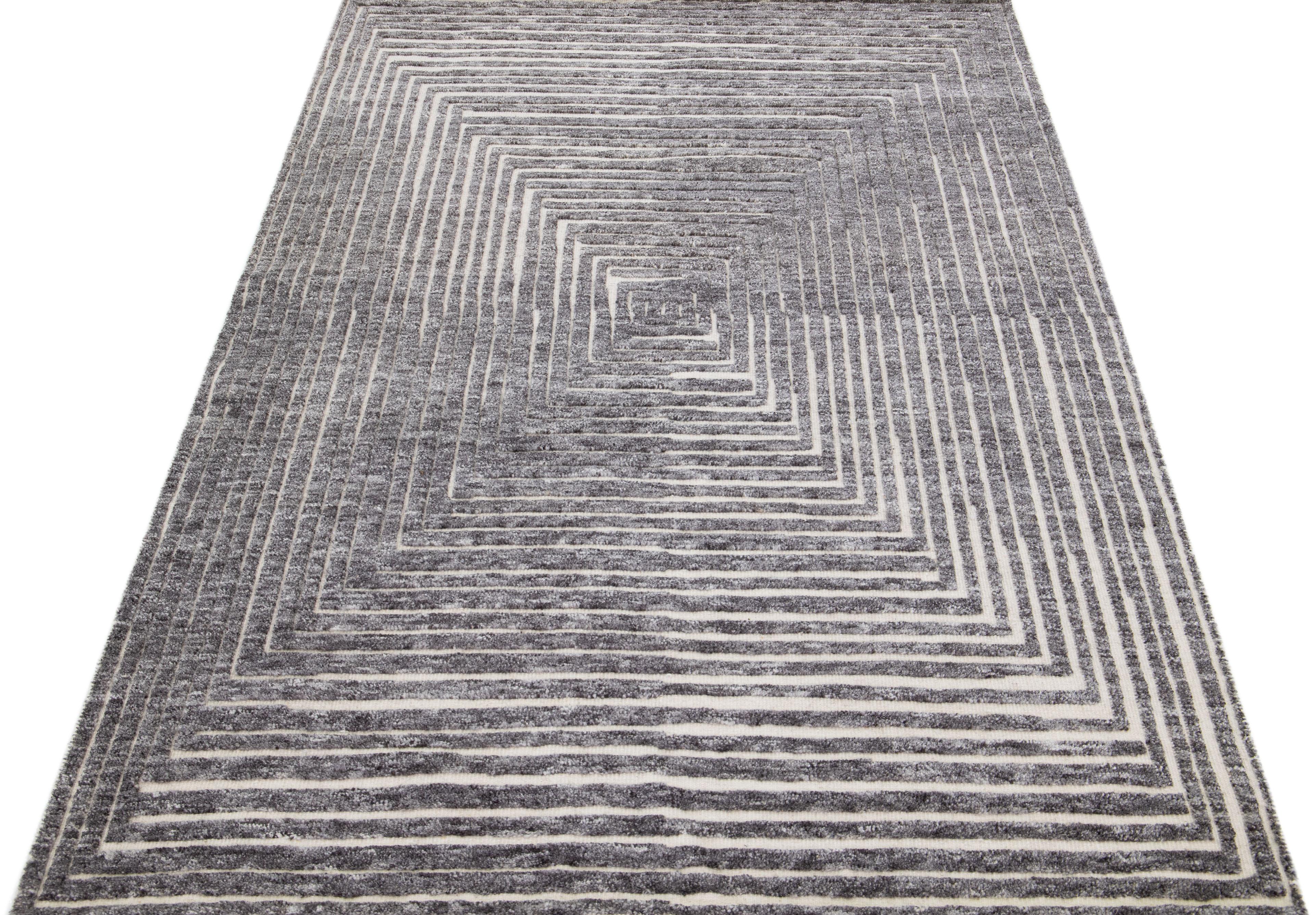 Beautiful modern Moroccan-style hand-knotted wool rug with a beige color field. This rug is part of our Apadana's Safi Collection and features an Op Art squares seamless design in gray.

This rug measures: 5'1