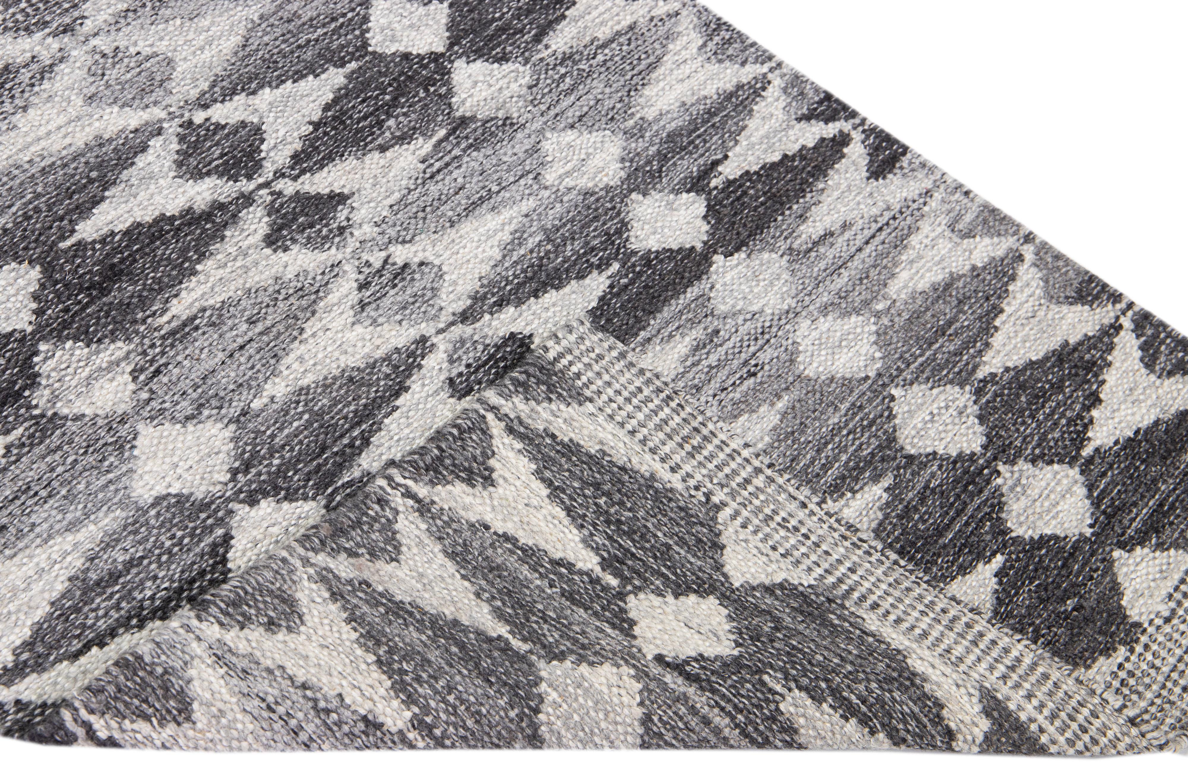 Beautiful modern Swedish-style wool rug with a gray field. This piece has white accents featuring a gorgeous all-over geometric abstract design.

 This runner measures: 3'2'' x 21'10''.

Our rugs are professional cleaning before shipping.