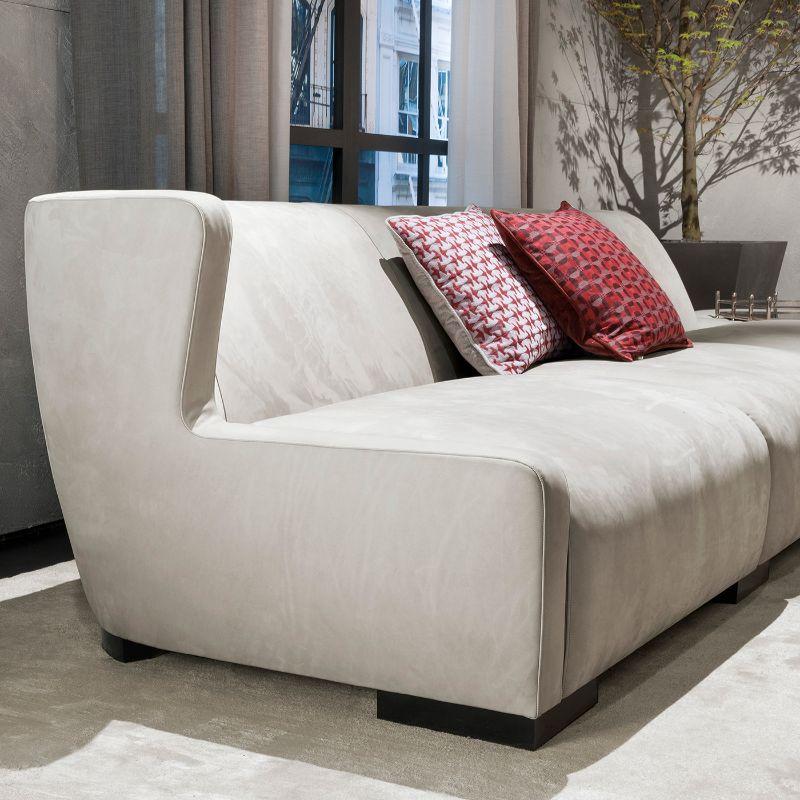 Gorgeous and elegant in its clean and simple design, this three-seat modular sofa is entirely upholstered with gray Nabuk leather, also available in fabric. Comprised of four additional cushions, a matching pouf is also available upon request.