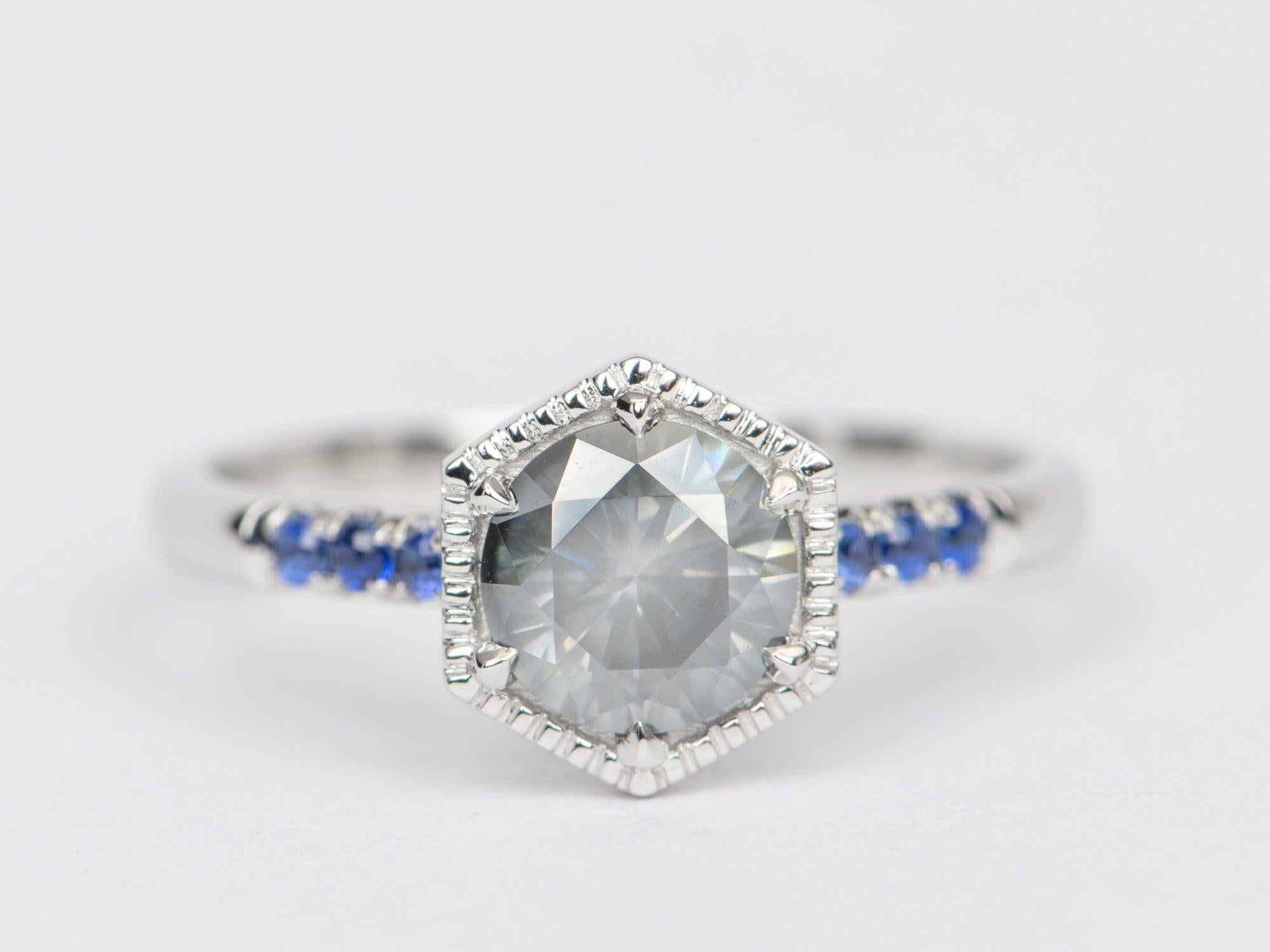 ♥ Solid 14K white gold ring set with a hexagon-shaped grey Moissanite in the center with 3 blue sapphires on each side on the band
♥ The overall setting measures 9mm in width, 8mm in length, and sits 5.2mm tall from the finger

♥ US Size 7 (Free