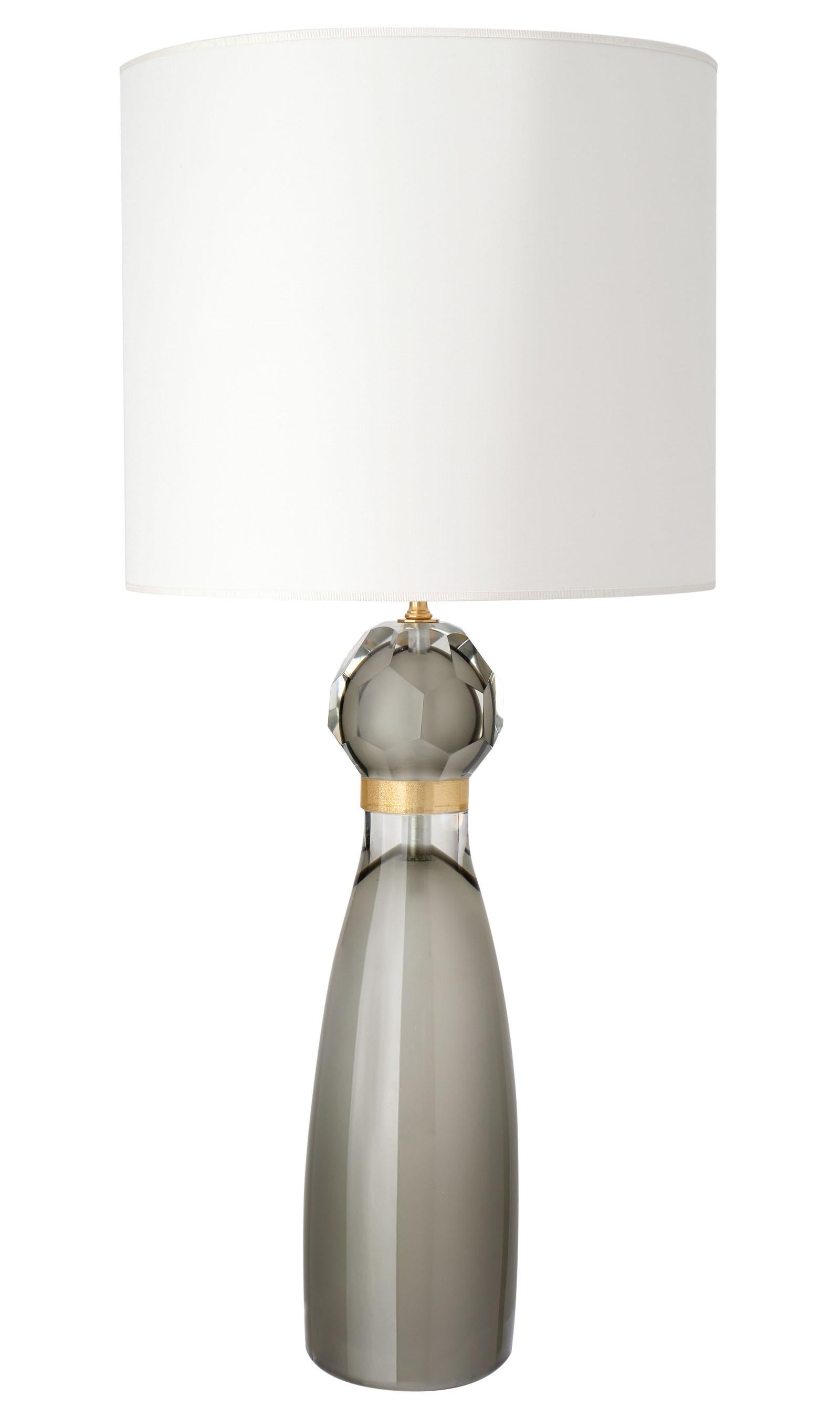 Italian hand blown Murano glass table lamps, in polished pearl gray glass fading to clear just below 23-karat gold flecked rings. At once formal and nonchalant, these sleek lights are sure to take your space to the next level. We were seduced by the