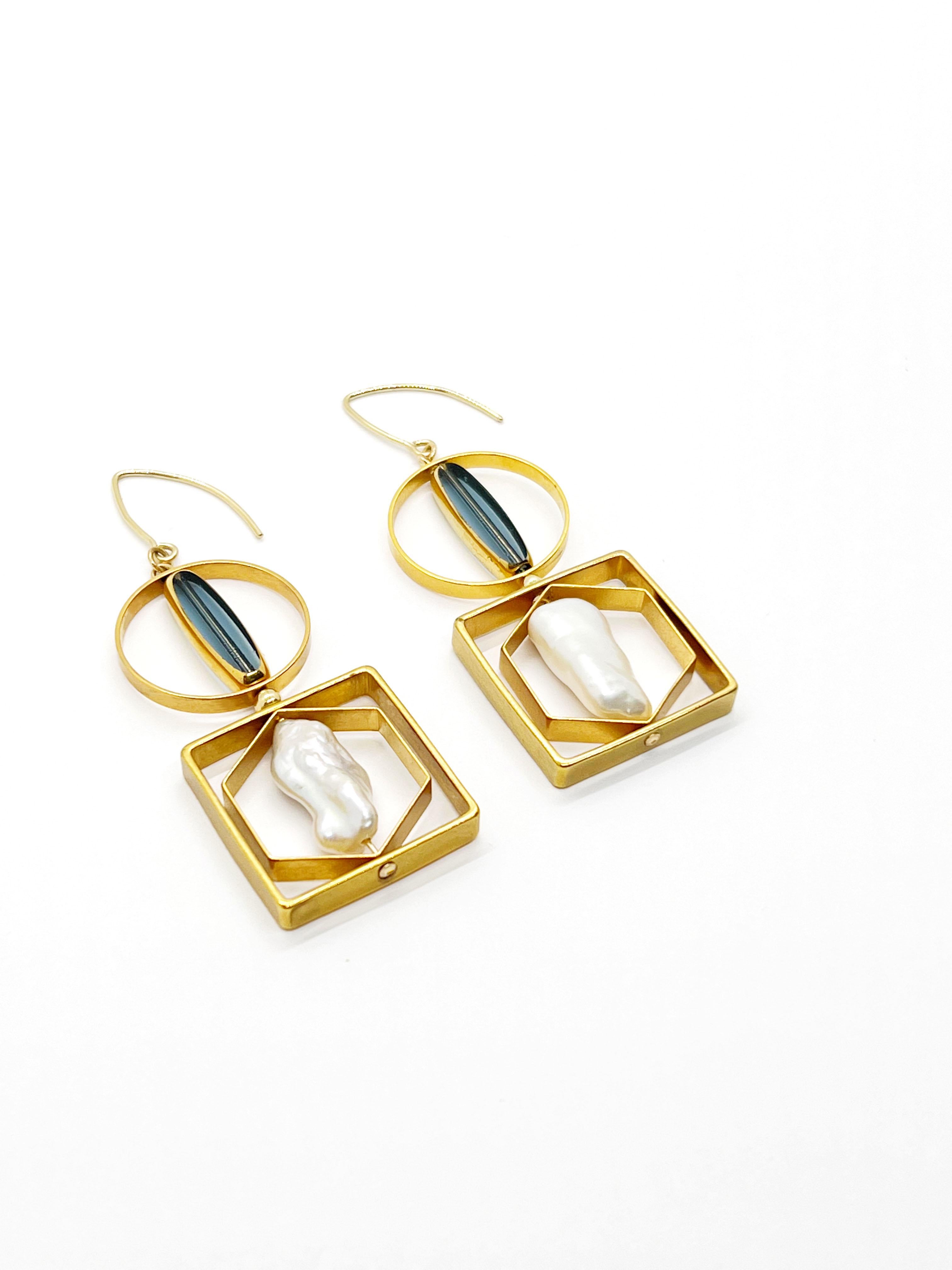 These earrings are light weight. They may turn and reposition with movement. It is composed of German Vintage Glass Beads that are edged with 24K gold. It is incorporated with Biwa freshwater pearls set in a geometric frame.

The vintage glass beads