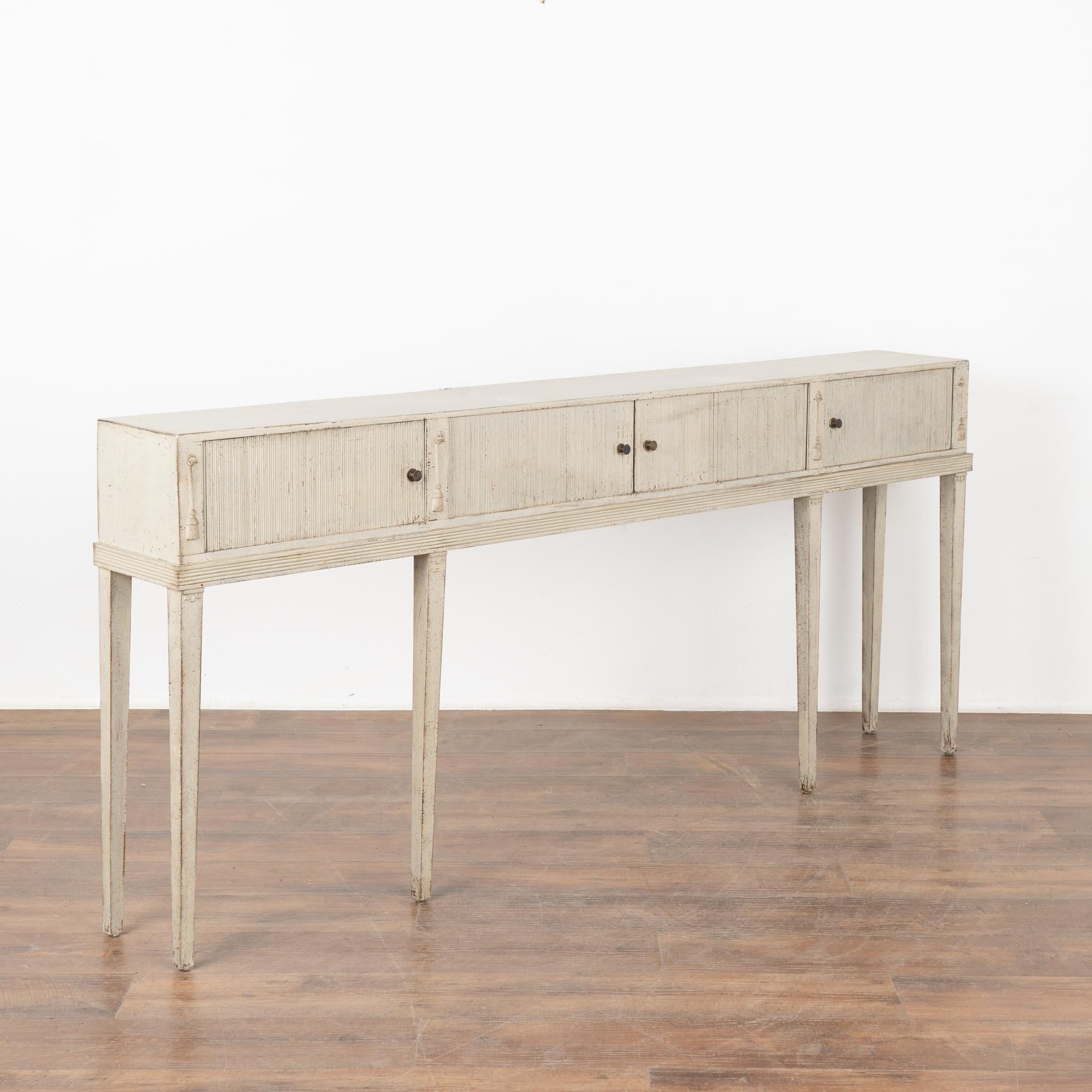 Elegant antique sideboard from Sweden with six elongated tapered legs, in the Gustavian style and extremely narrow at only 10.25