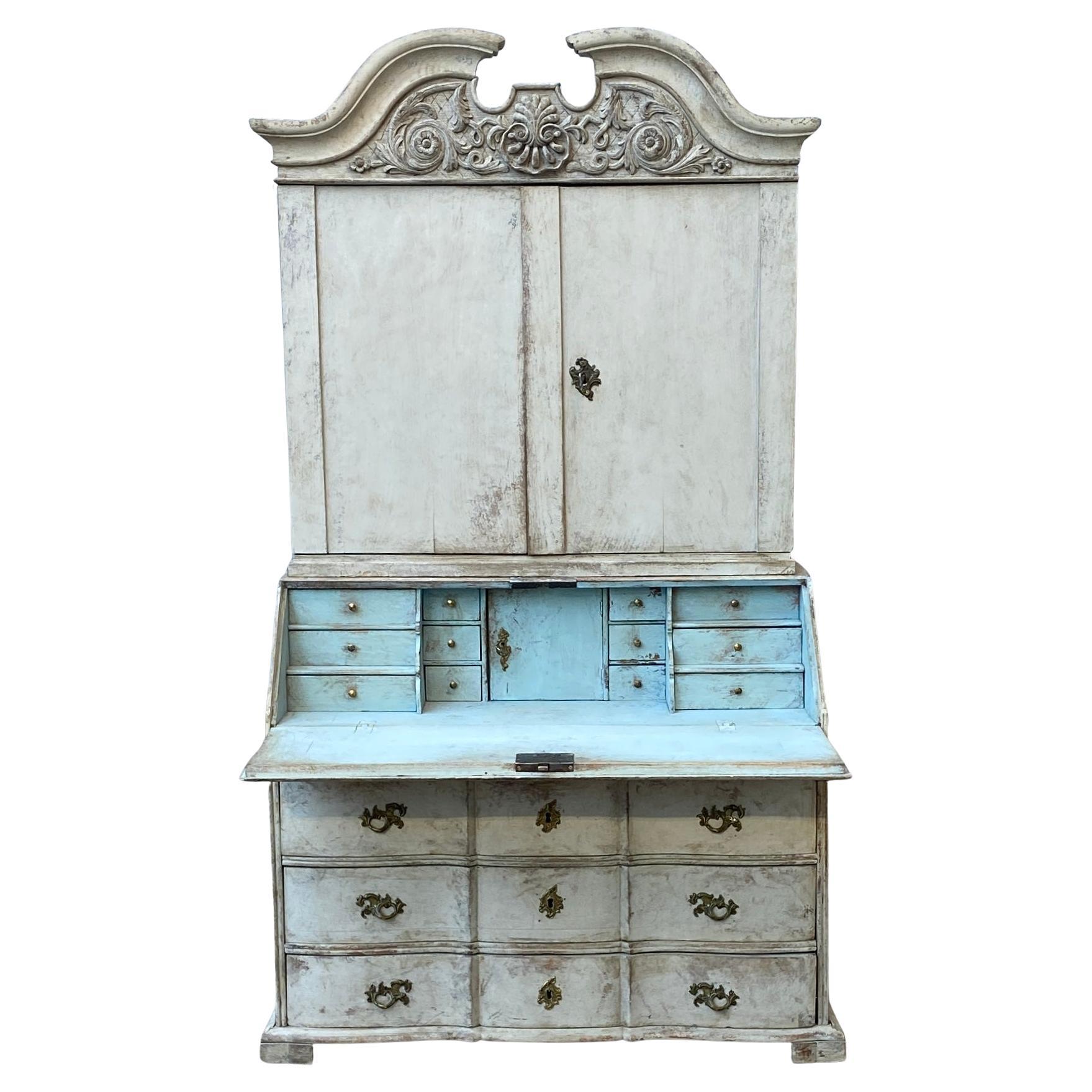Swedish Rococo Secretary and Cabinet in hand painted Gustavian Style Gray and Light Blue Interior, circa 1760s.
The base of the cabinet has 3 plus 1 drawers with the original brass hardware. The top has two doors that when open shows 2 shelves.