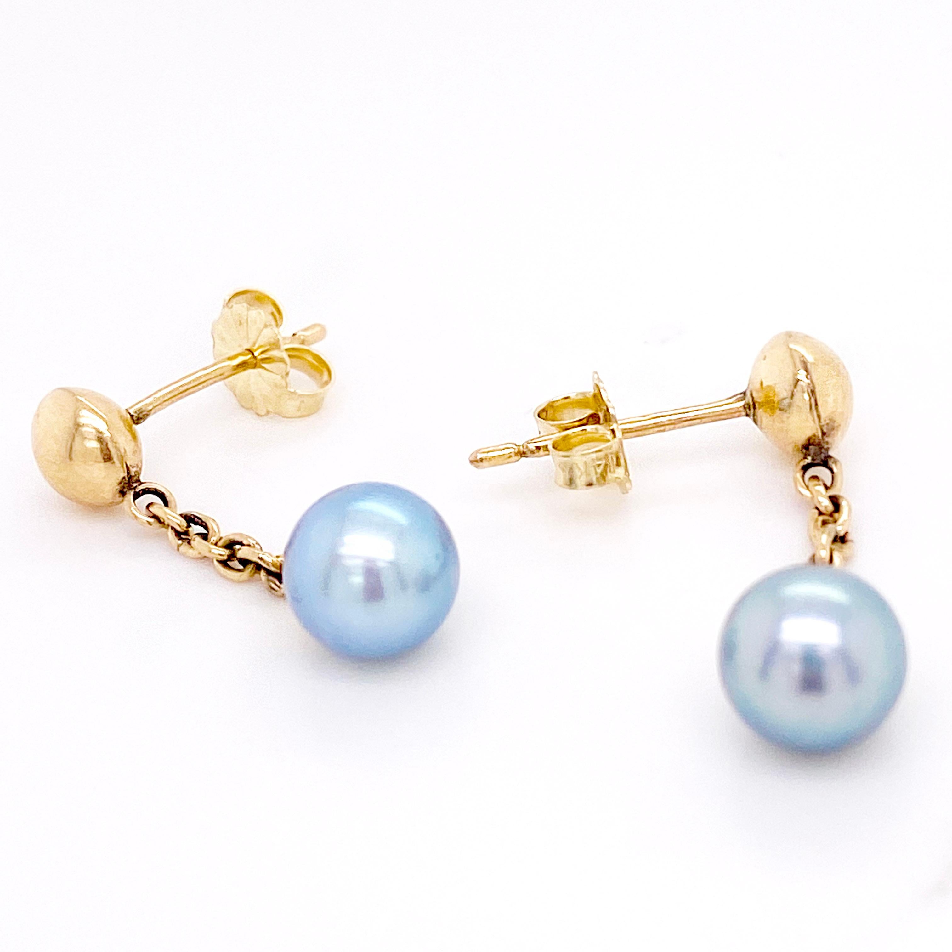These gorgeous gray pearl earrings are perfect for anyone! They are genuine cultured pearls that have a lovely luster and orient. The post ad links are solid 14 karat yellow gold and the ball post is 6.5 millimeters. These earrings can dress up or